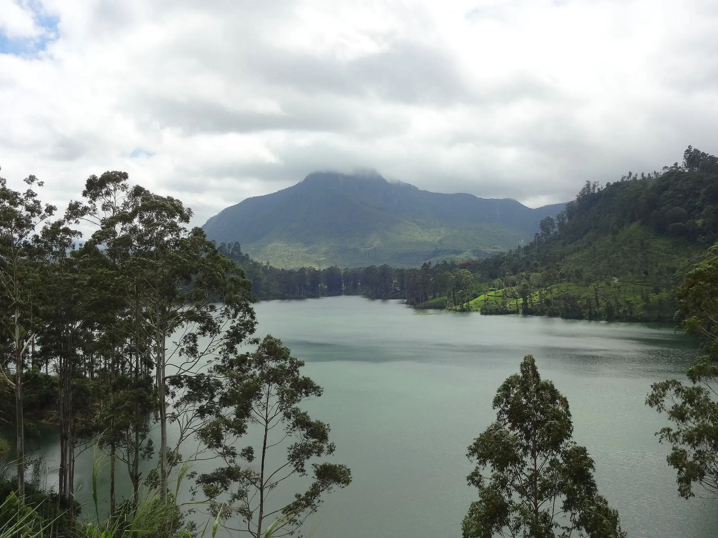 Maskeliya Reservoir in the hill country with the cone of Adam's Peak in the distance