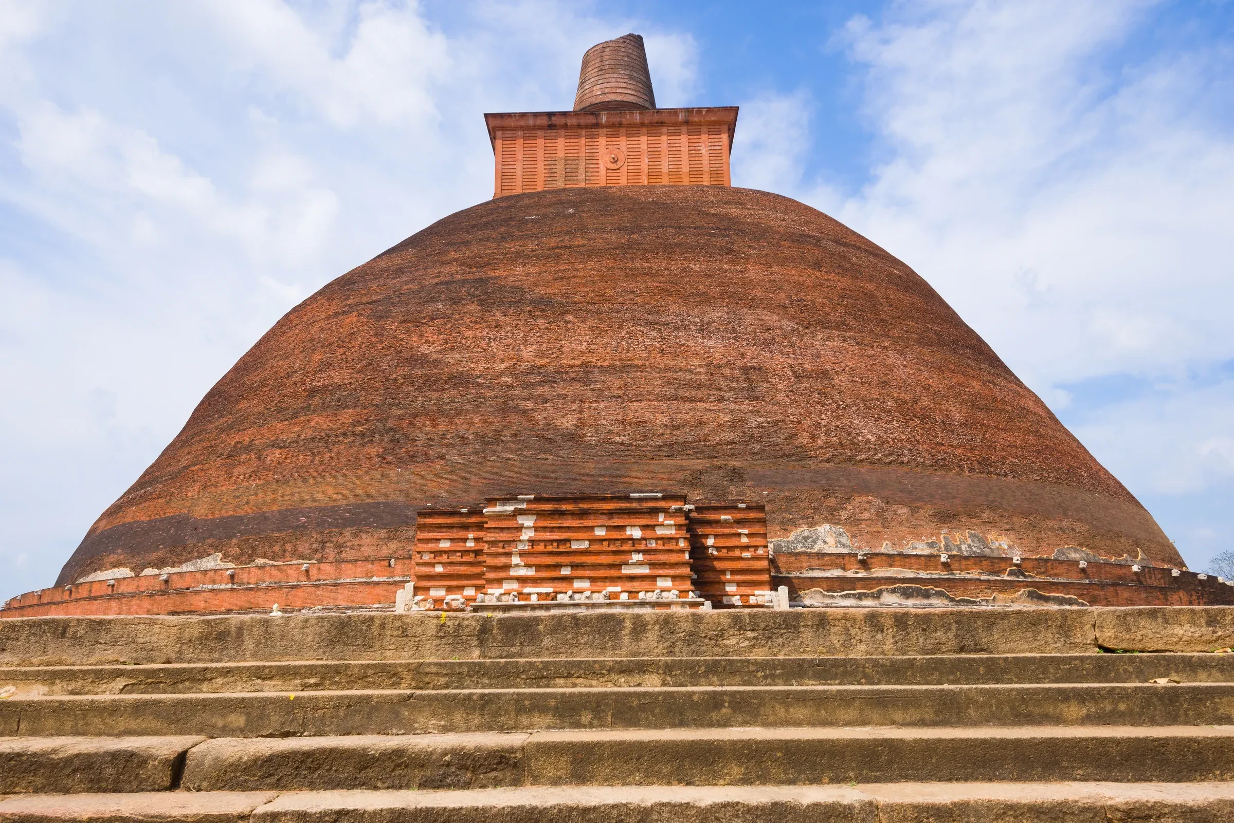 Jetavanaramaya's weathered brick dagoba rising above the trees at Anuradhapura
