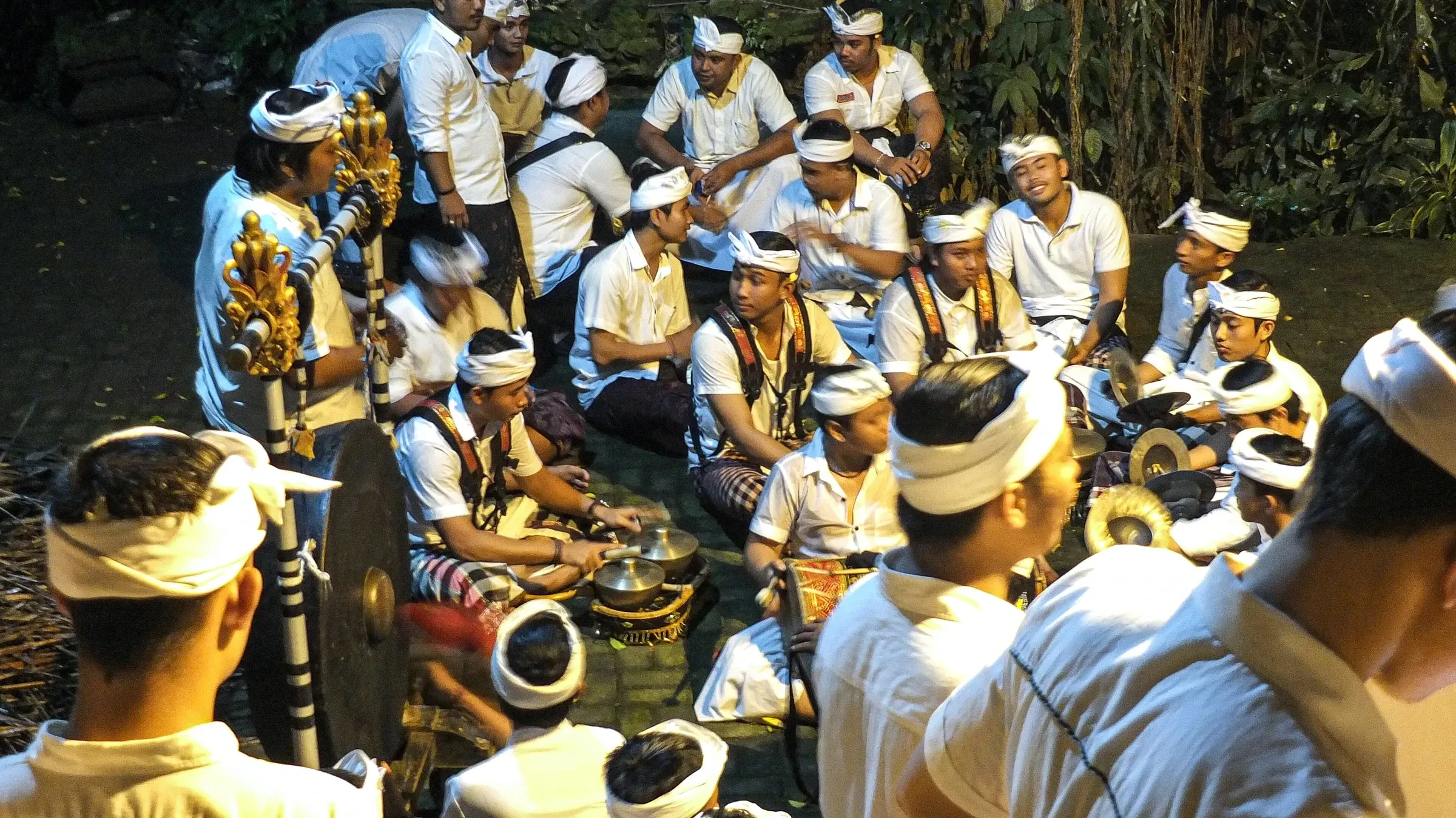 Musicians in white shirts and headcloths playing a gamelan orchestra at Campuhan near Ubud