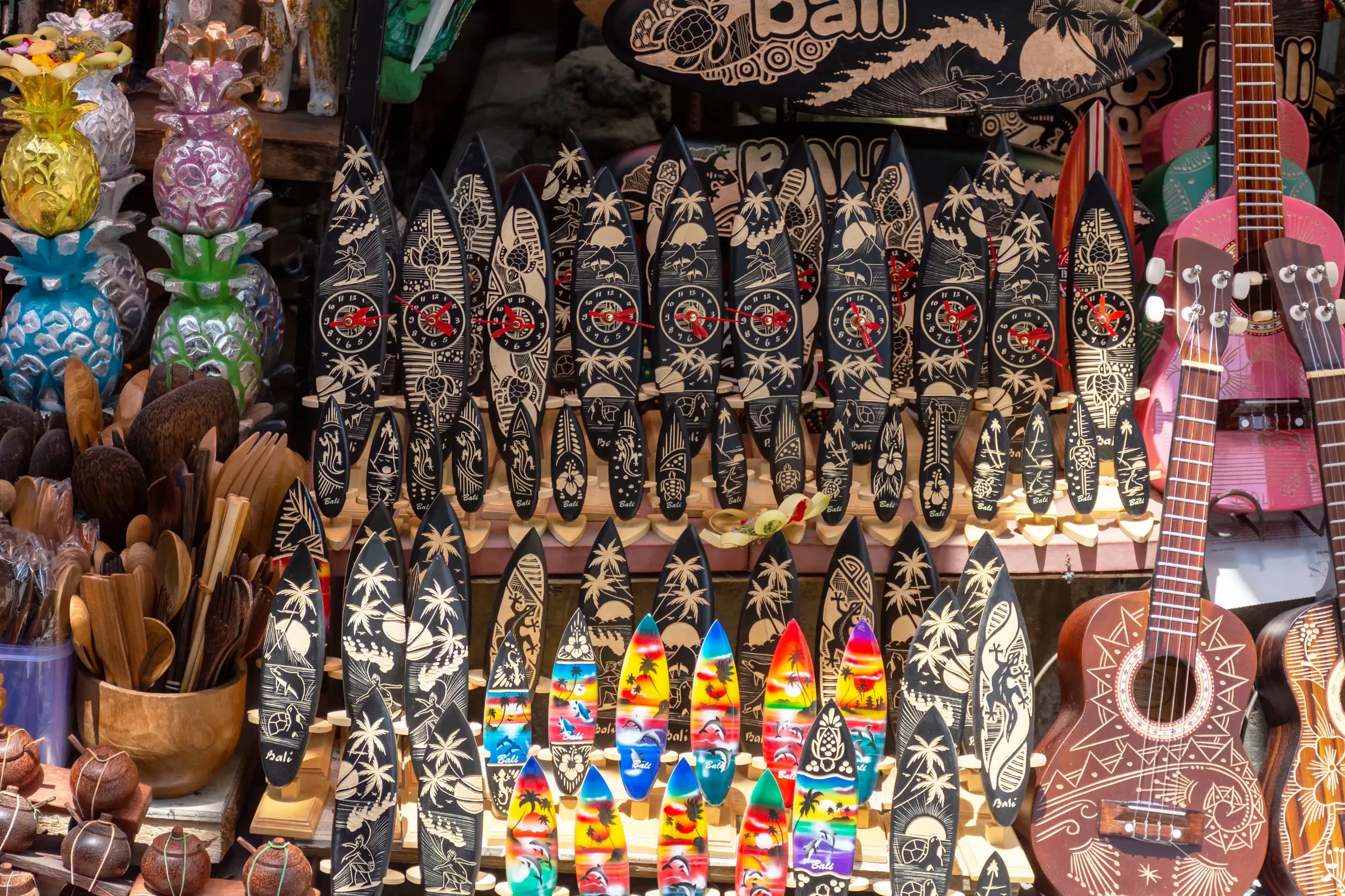 Carved masks and wooden crafts for sale at a market stall in Ubud