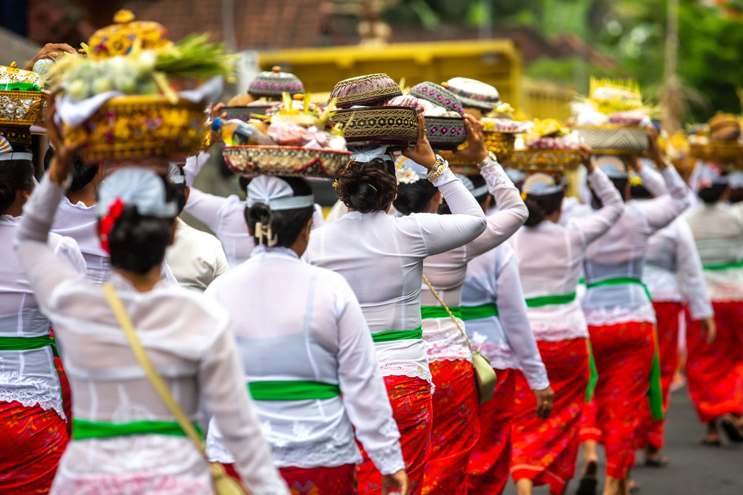 Balinese women carrying offerings on their heads during a temple ceremony