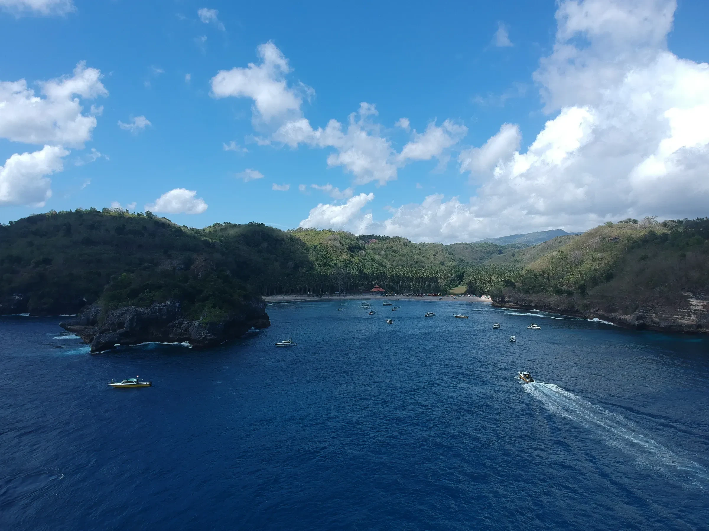 Crystal Bay on Nusa Penida, with boats on the water below green headlands