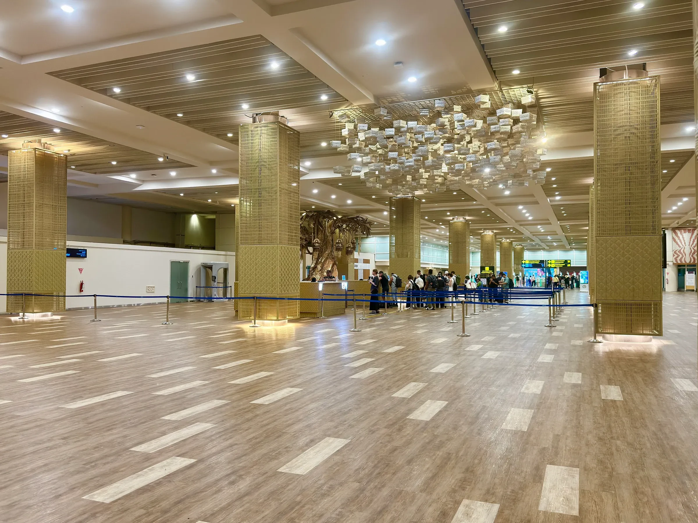 A wide, empty hall inside the international terminal at Ngurah Rai airport, Bali