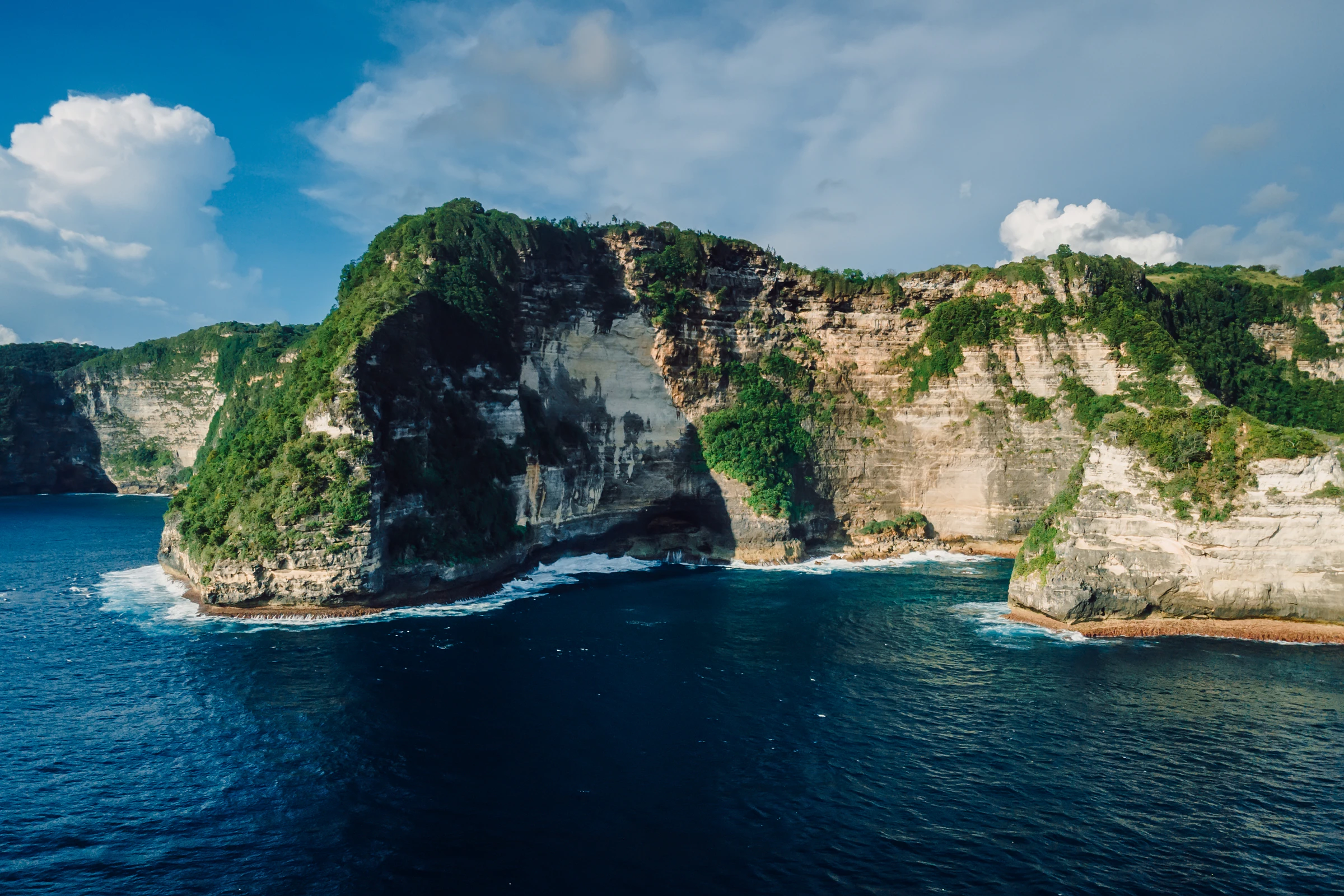 An aerial view of dramatic cliffs along Bali's coastline