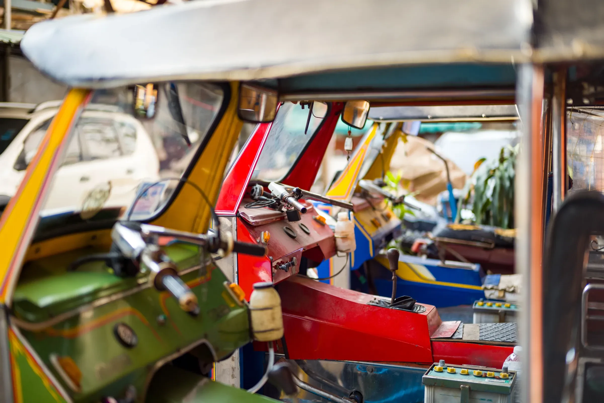 The colourful interior of a tuk-tuk on a Bangkok street