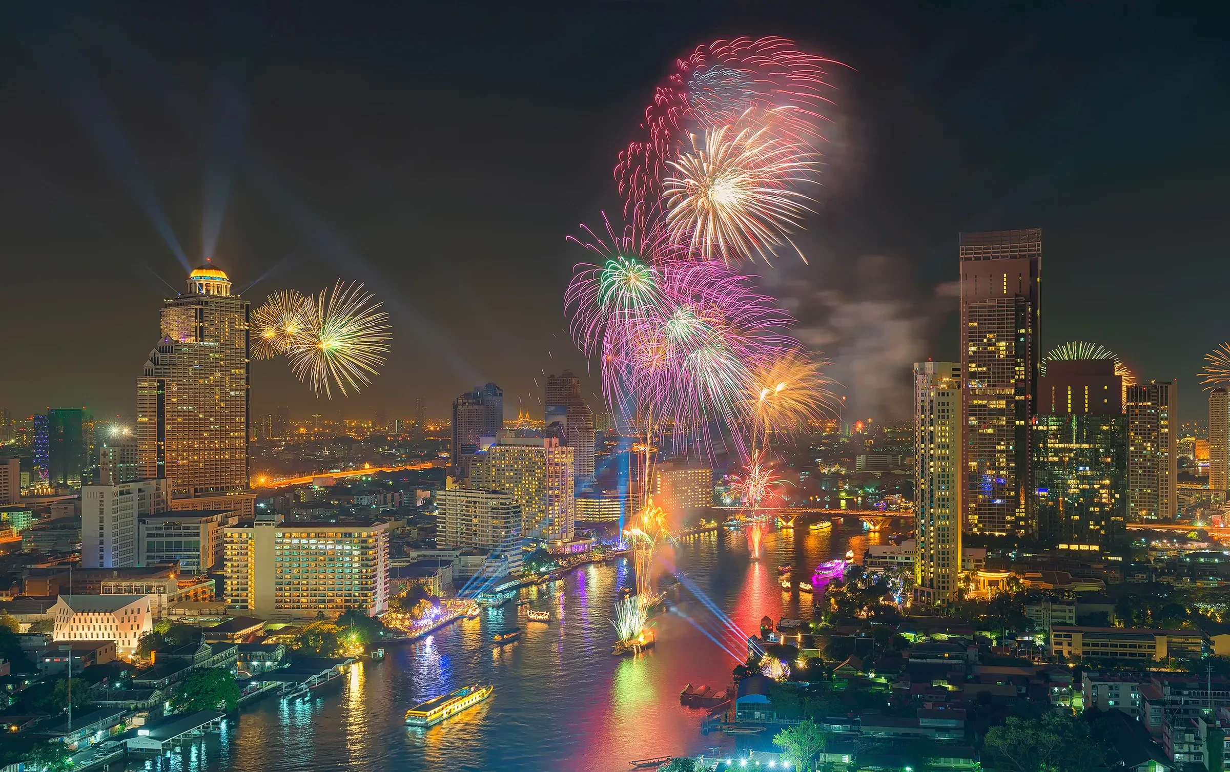 Fireworks over Bangkok's skyline and the Chao Phraya River at night