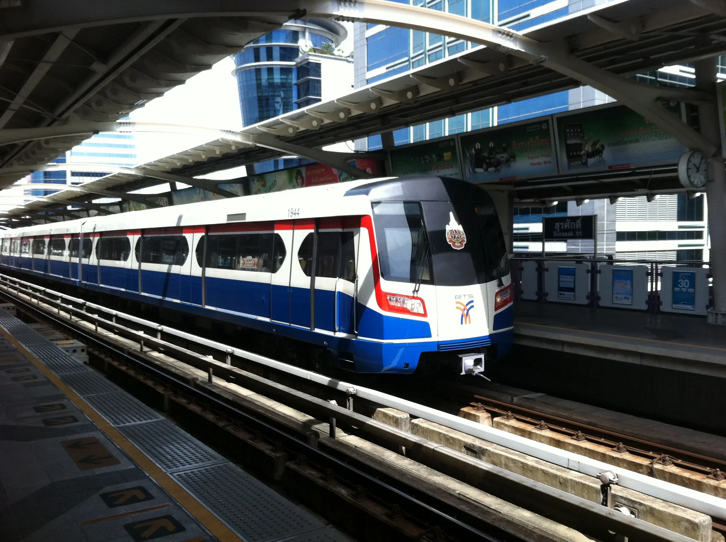 A Bangkok BTS Skytrain train arriving at an elevated station