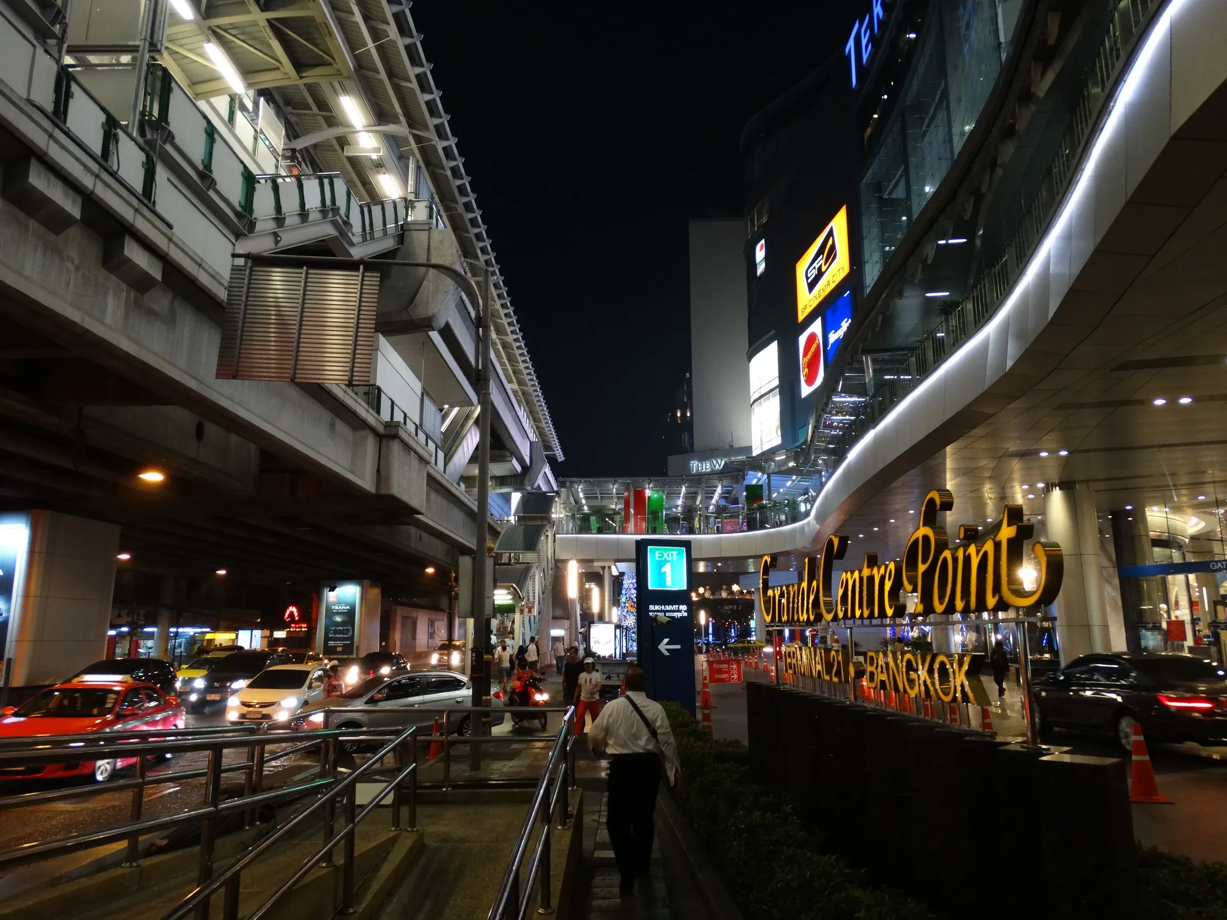 Sukhumvit Road at night, with the BTS Skytrain tracks above the street