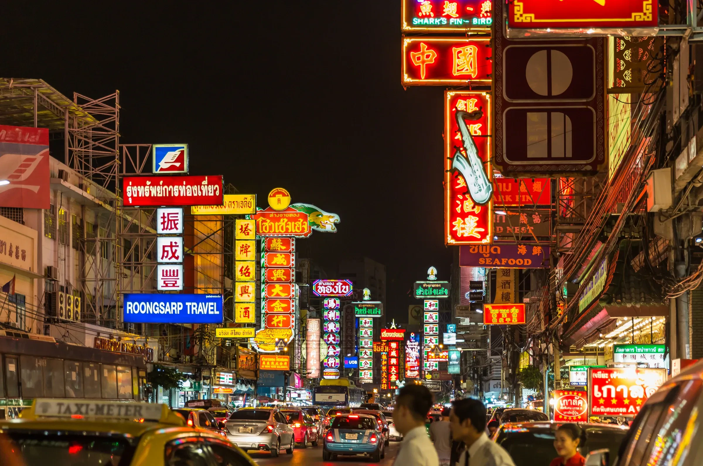 Neon signs lighting Yaowarat Road in Bangkok's Chinatown at night