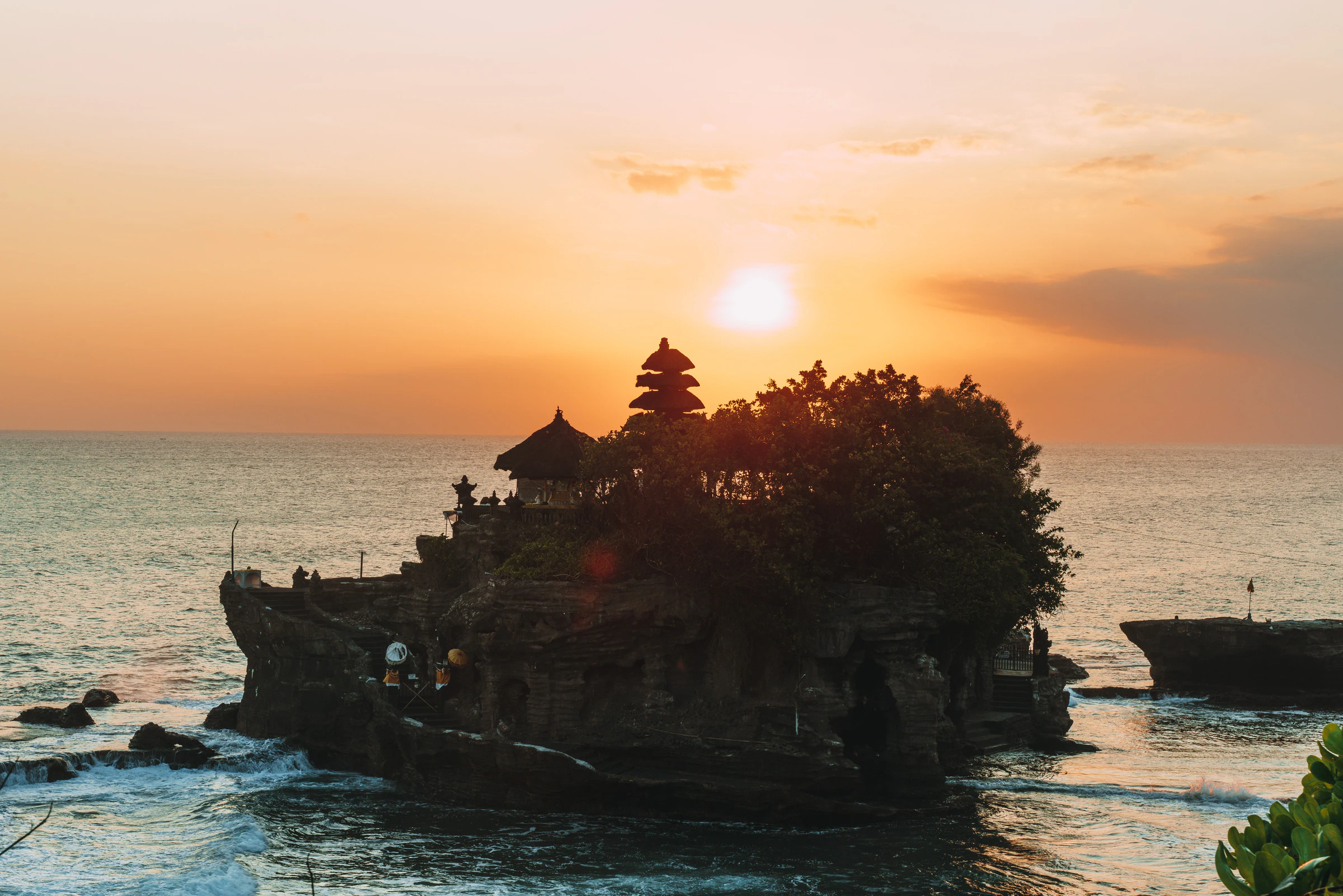 The sea temple of Tanah Lot on its rock at sunset