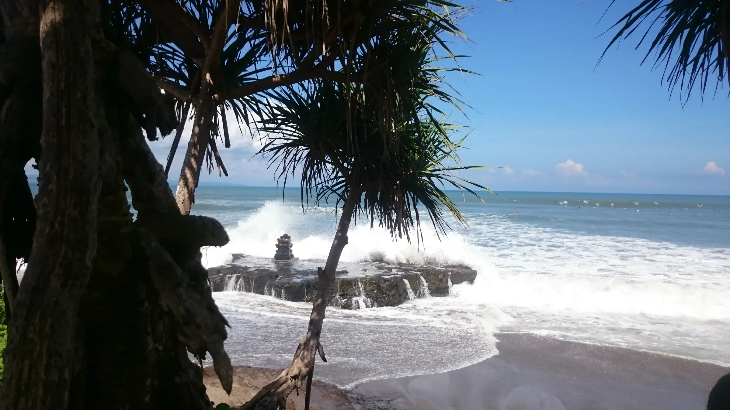 Waves breaking on the rocks beside the sea temple at Batu Bolong beach, Canggu