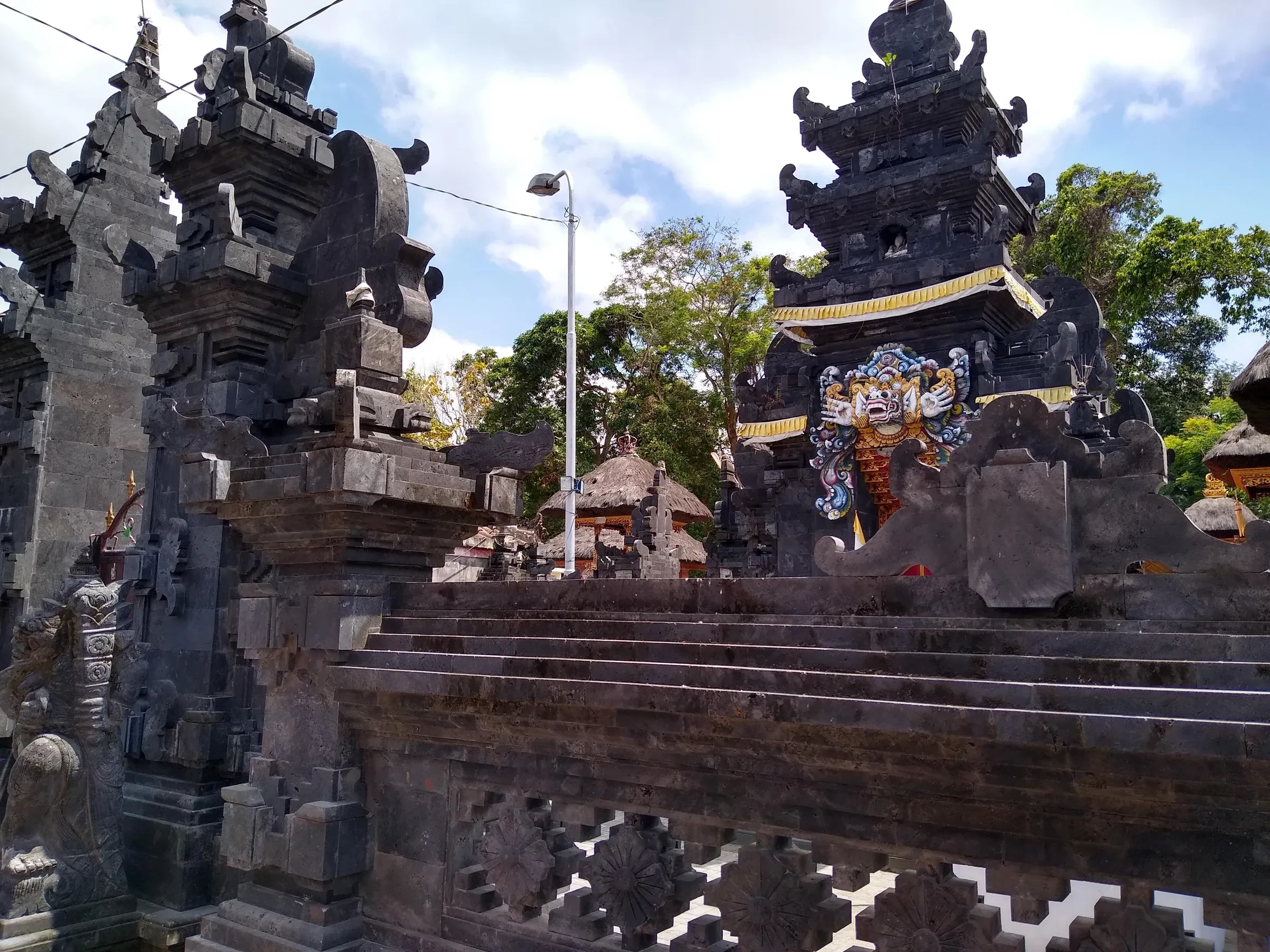Carved stone gateway and shrines at Pura Batu Mejan, a temple in Canggu