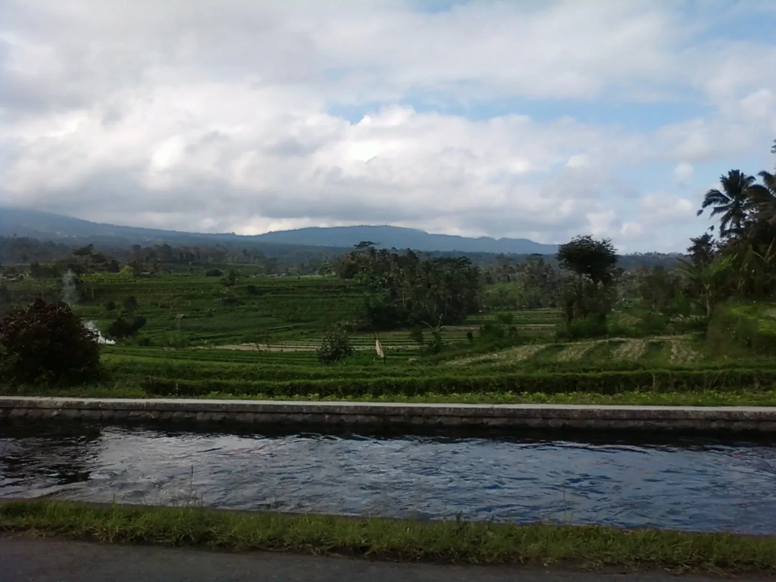 Terraced rice fields and distant hills in the Sidemen valley in east Bali