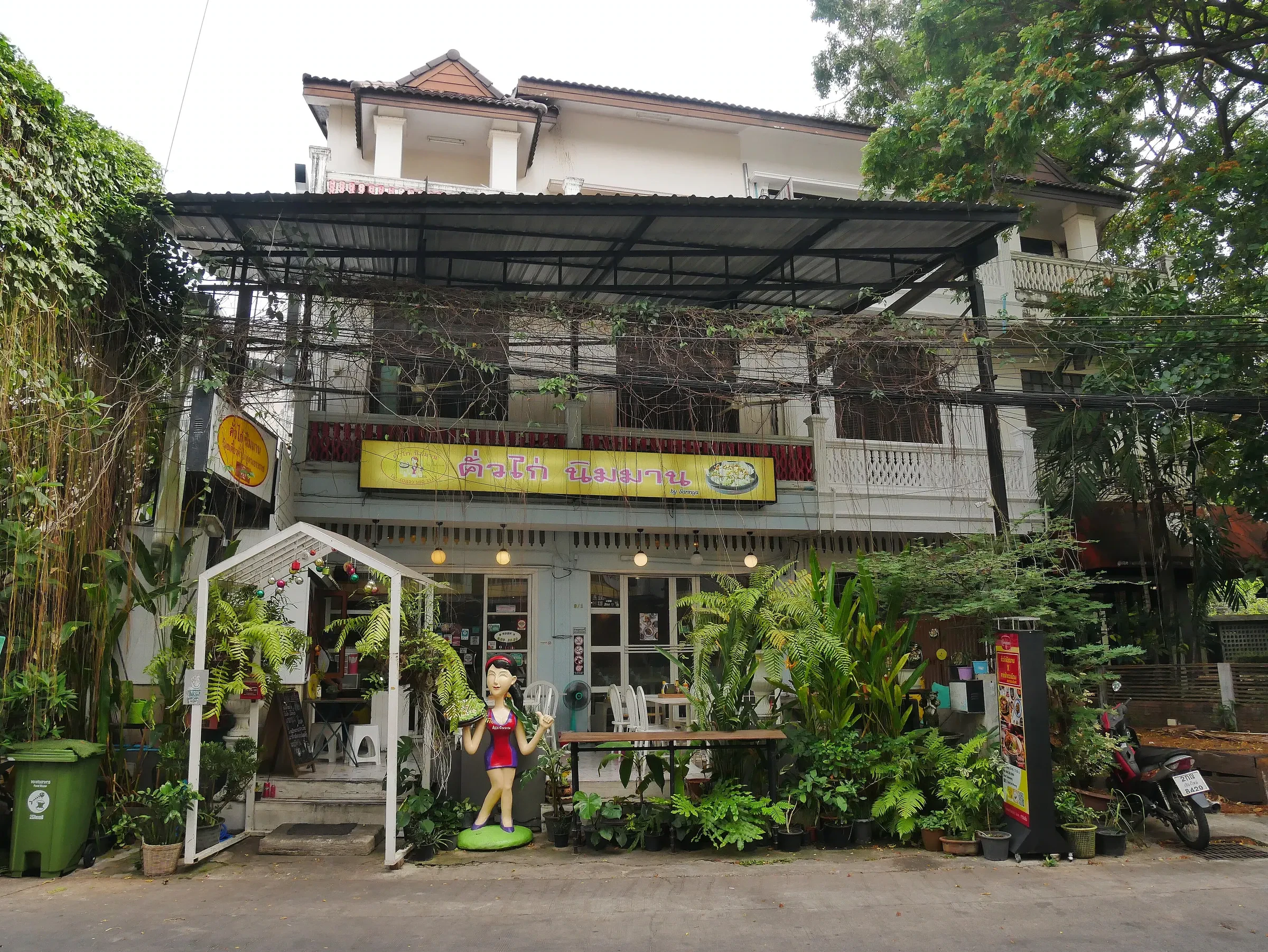 A plant-covered cafe building on Nimmanhaemin Road in Chiang Mai