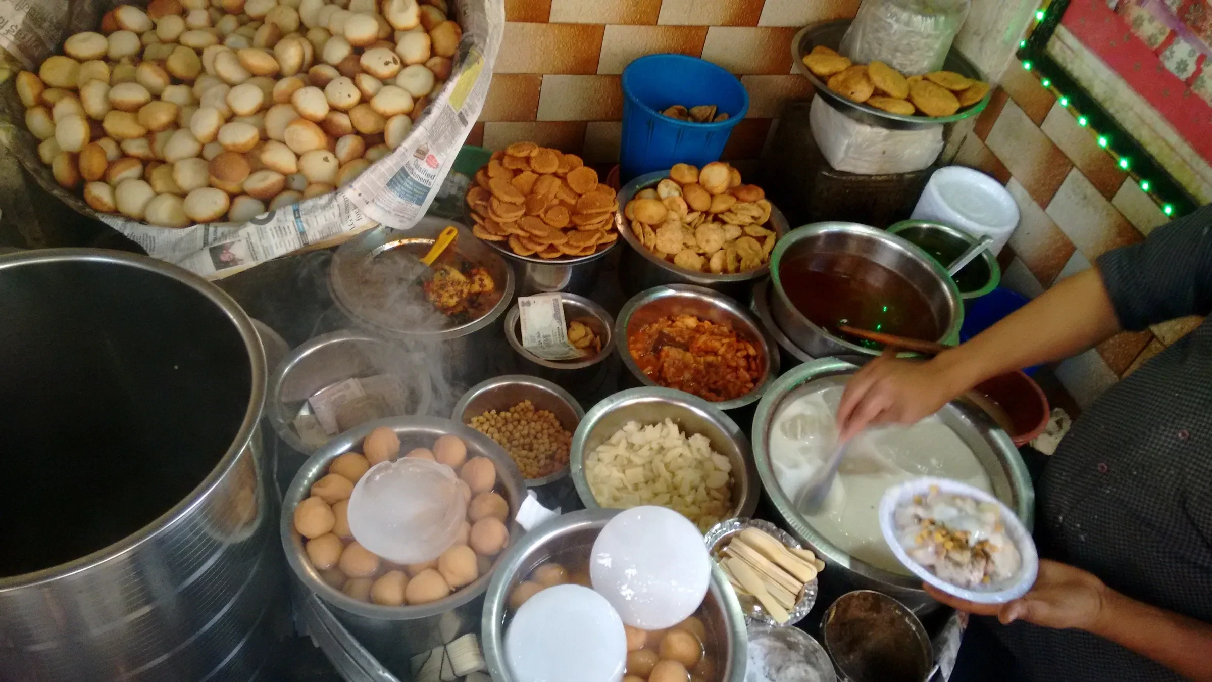 A chaat stall's trays of snacks, chutneys and toppings at Chawri Bazar, Old Delhi