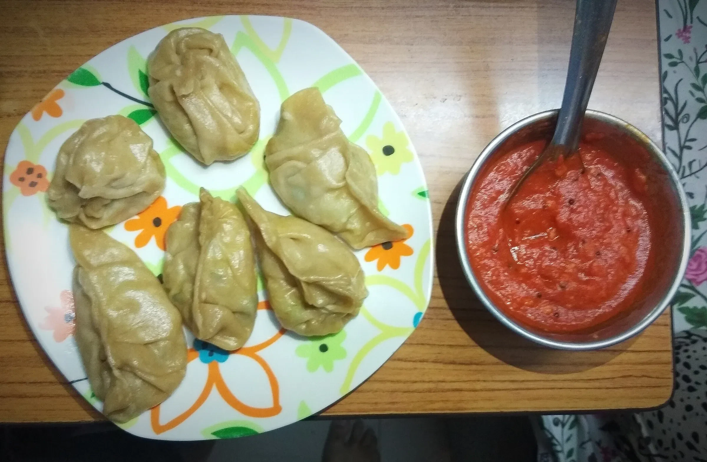 A plate of steamed momos with red chutney in New Delhi
