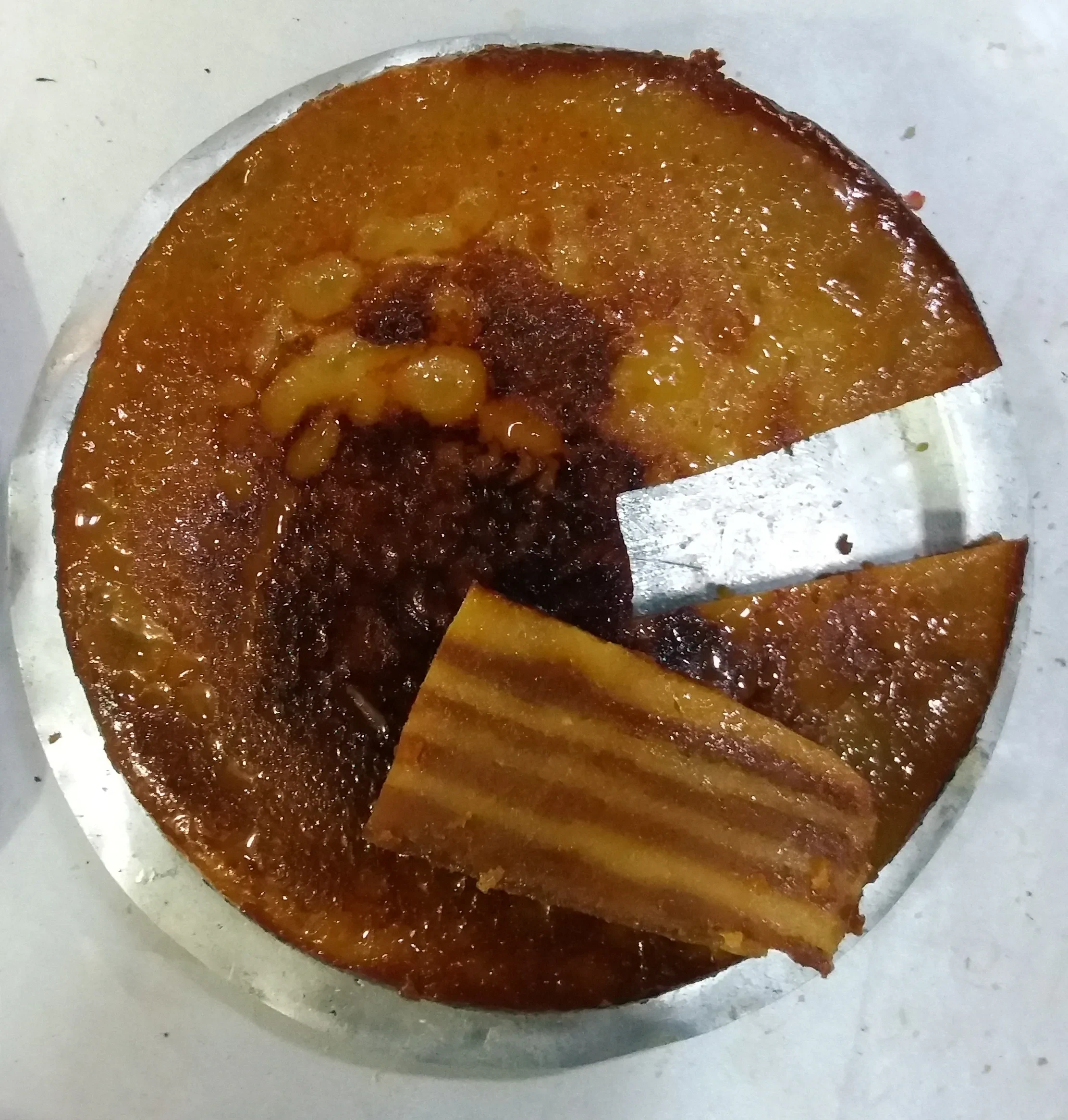 A home-made bebinca with a slice cut from the layers