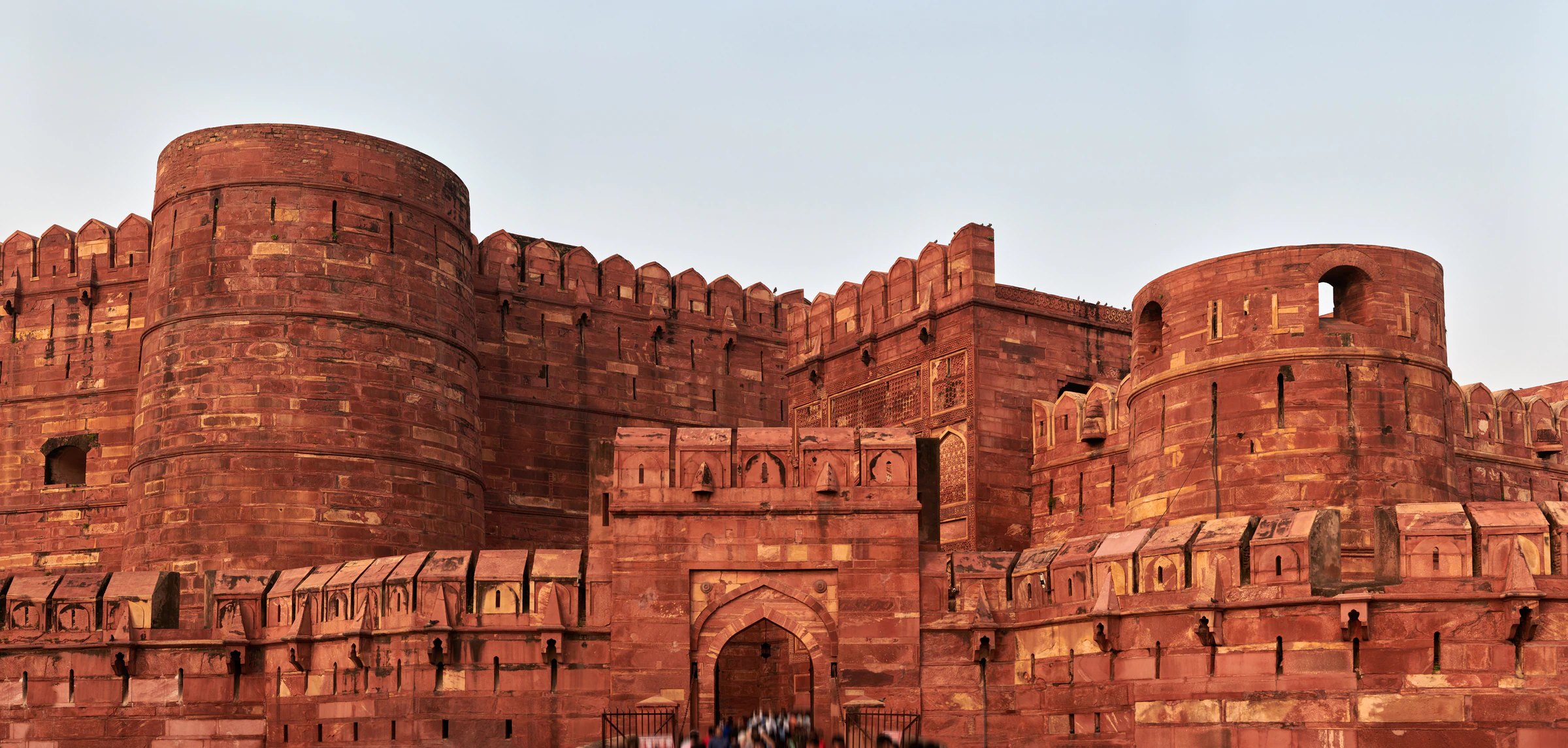 The red sandstone walls of Agra Fort on the banks of the Yamuna