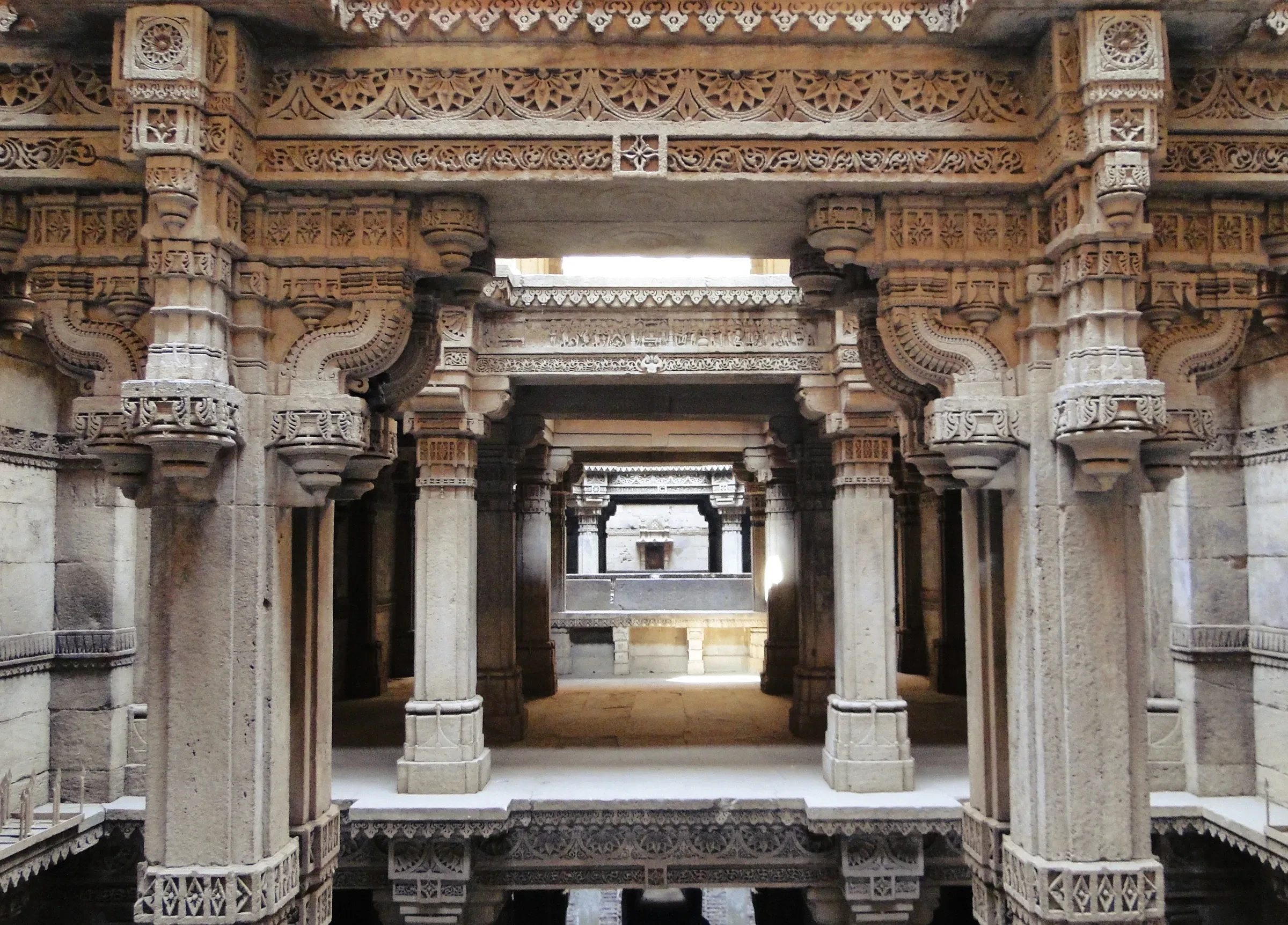Carved stone pillars and galleries inside the Adalaj Stepwell near Ahmedabad