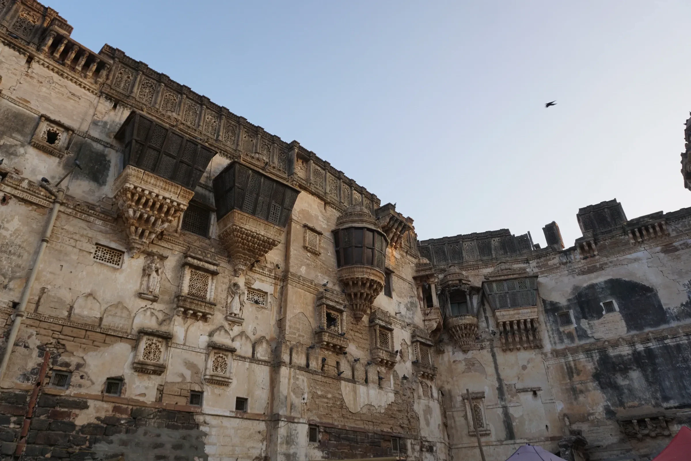The weathered stone facade and balconies of Aina Mahal in Bhuj, Kutch