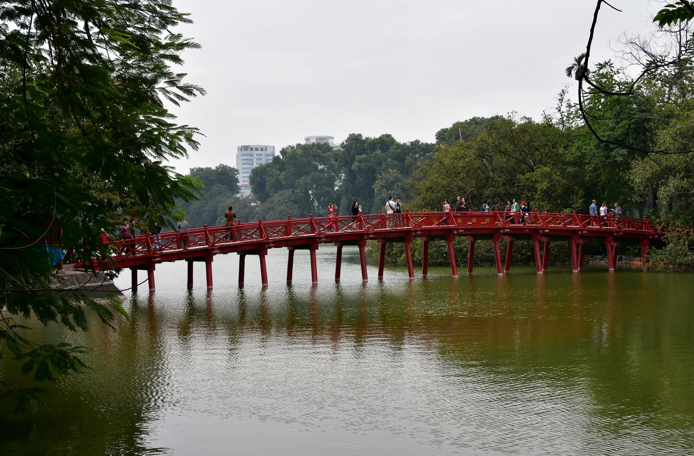 The red Huc Bridge across Hoan Kiem Lake in Hanoi