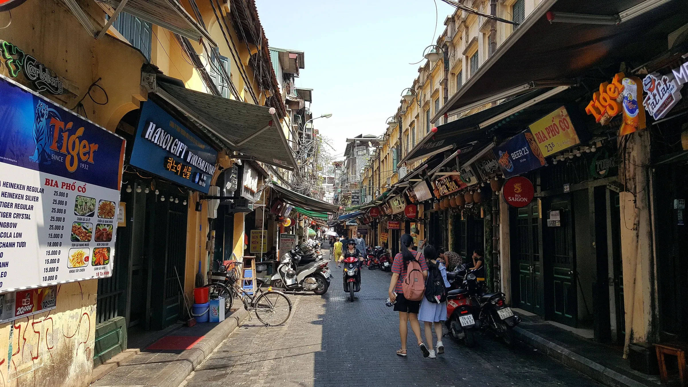 Ta Hien street in Hanoi's Old Quarter, lined with bar signs and small tables