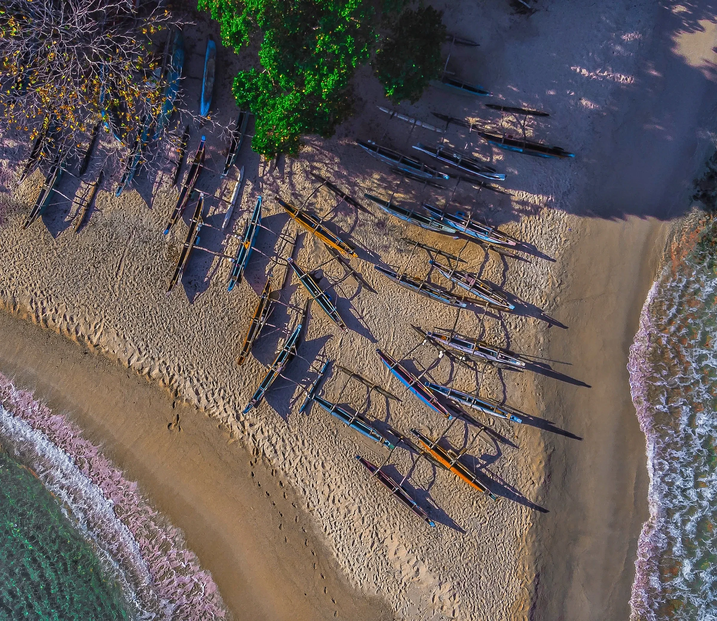 Traditional outrigger fishing boats drawn up on a beach near Dikwella