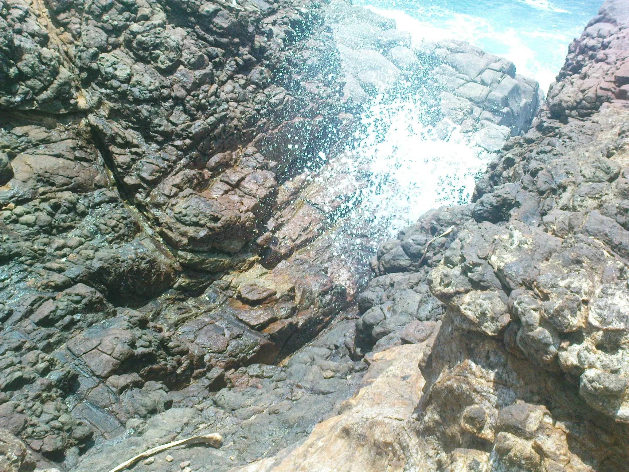 Spray rising through the rocks at the Hummanaya blowhole, Kudawella