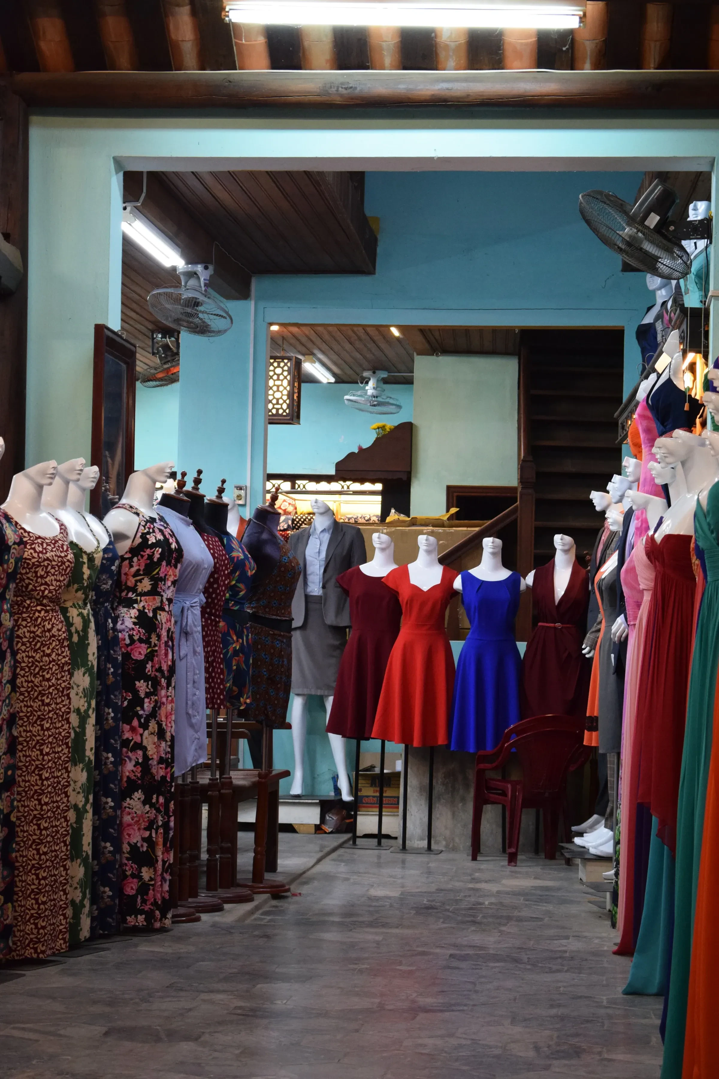 Dresses on display inside a tailor shop in Hoi An