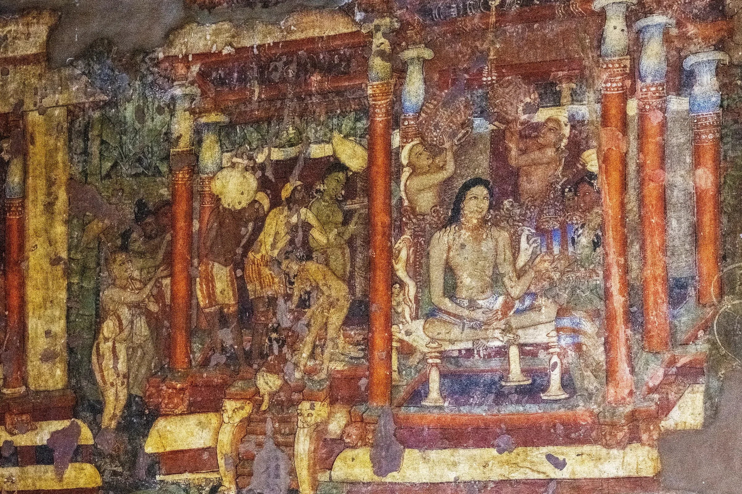 A painted mural of seated figures on a wall in Cave 1 at Ajanta