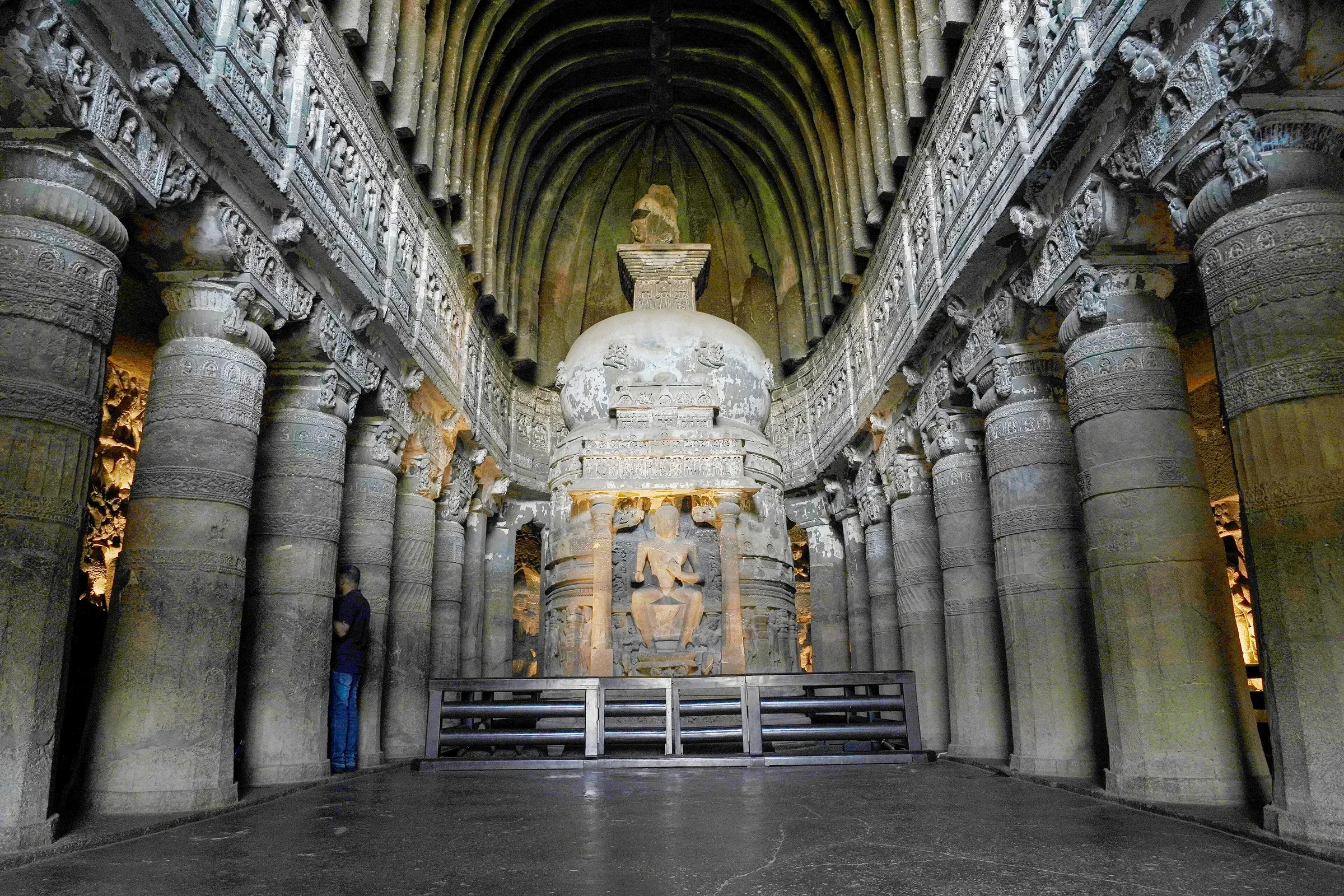 Rows of carved pillars leading to the stupa inside Ajanta's Cave 26