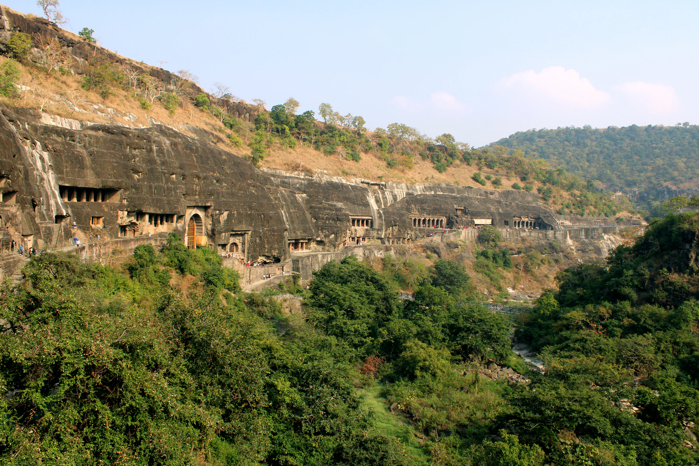 The horseshoe-shaped cliff and cave entrances at Ajanta, seen from across the gorge