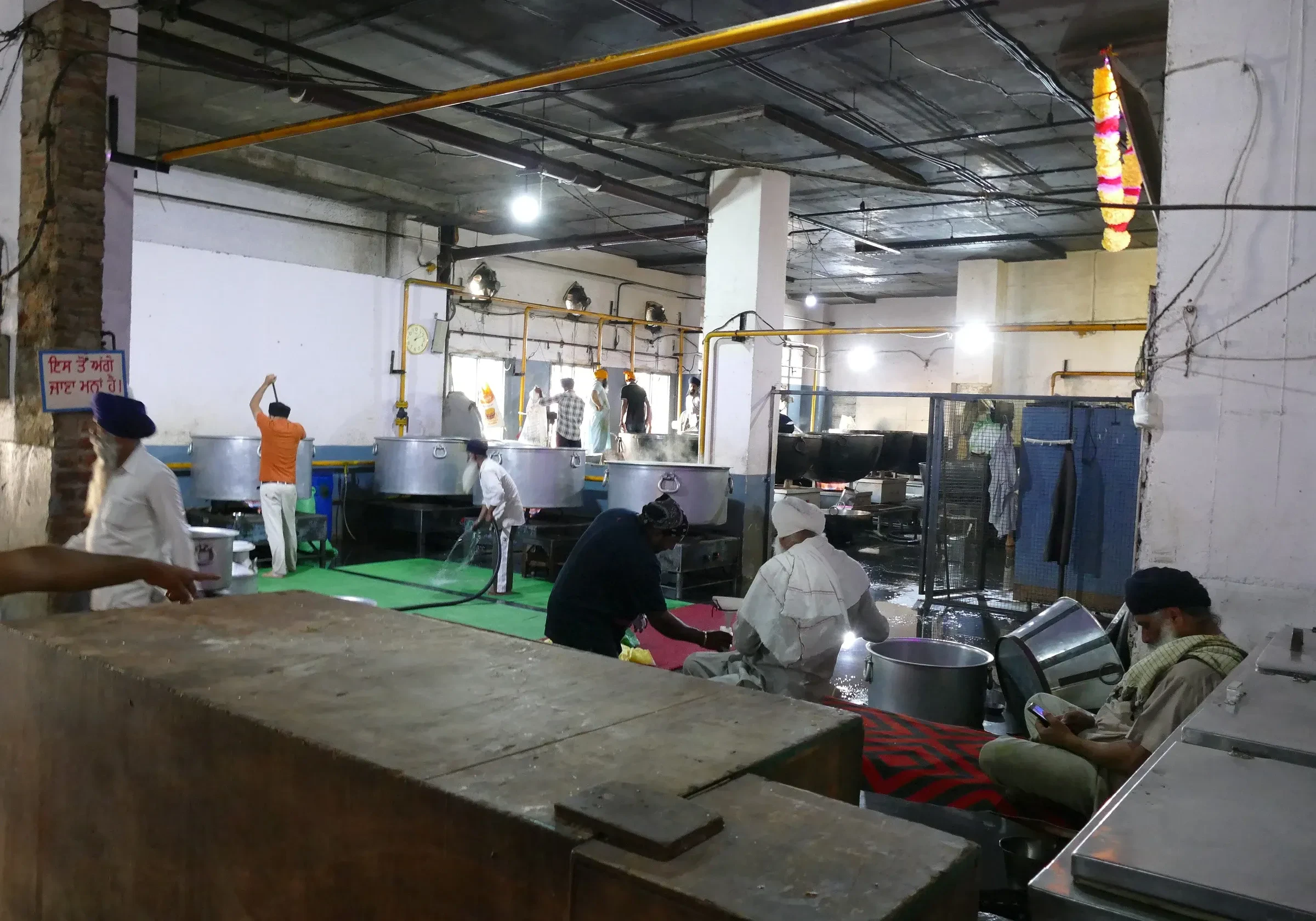 Volunteers working over big pots in the langar kitchen at the Golden Temple, Amritsar