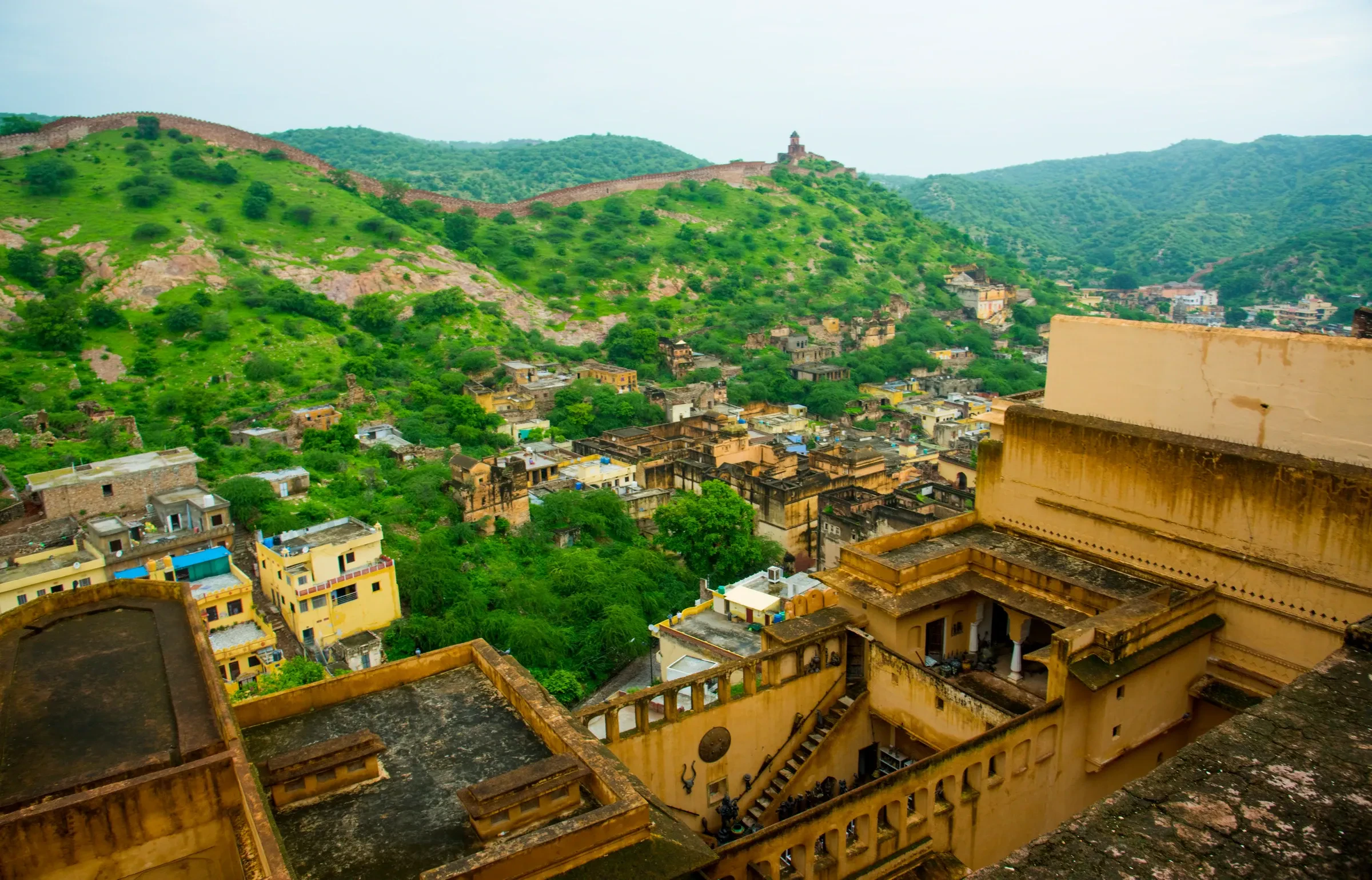 Rooftops of old Jaipur and green hills seen from the top of Amber Fort.