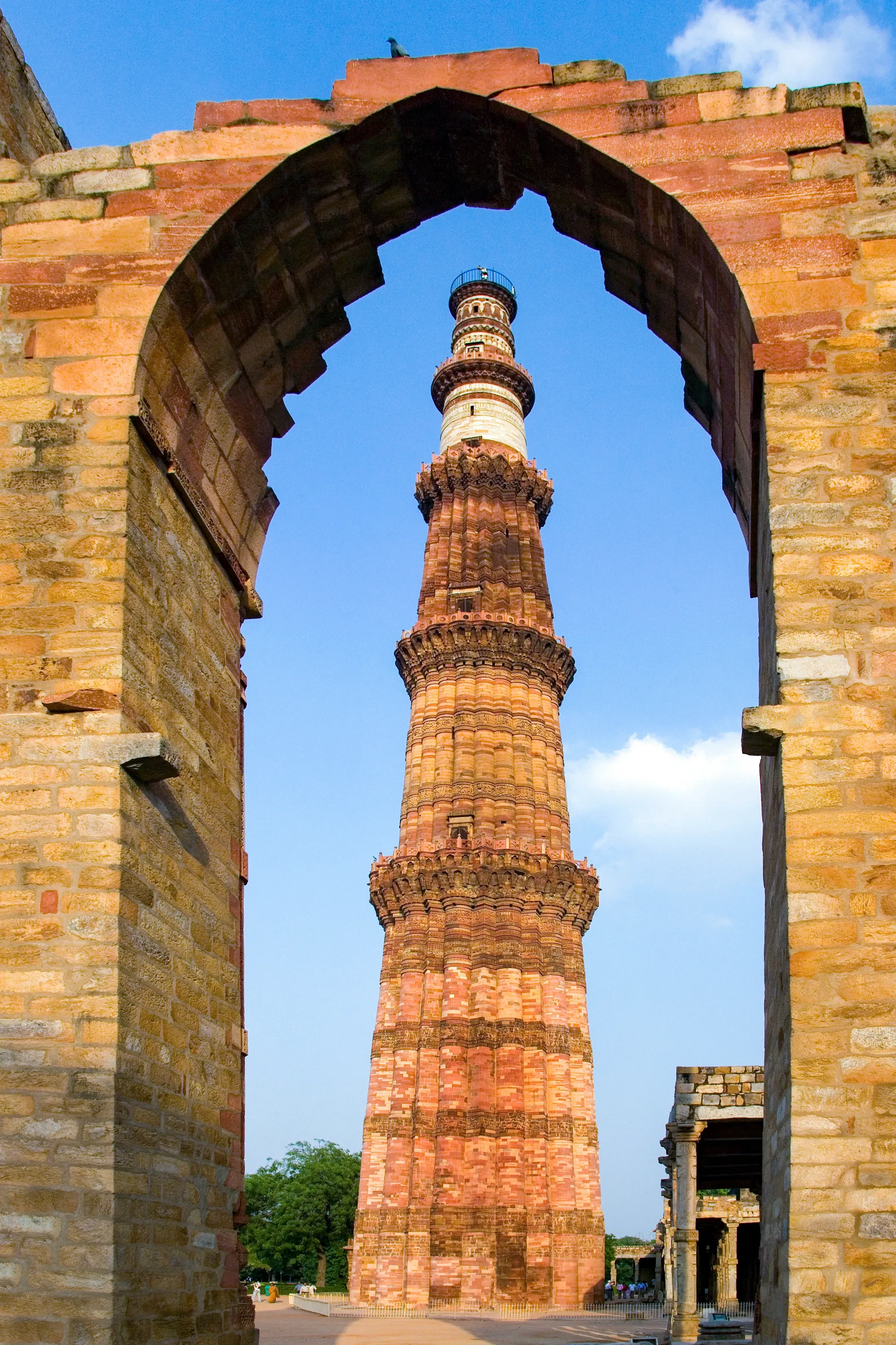 Qutub Minar rising above its sandstone complex