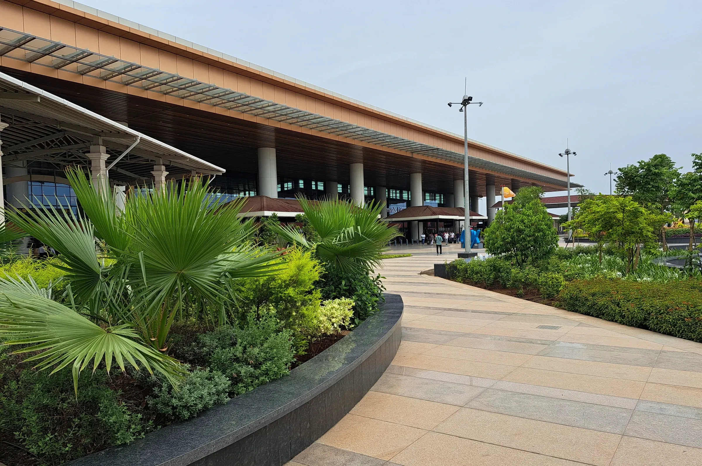 A covered walkway and palm planting outside the terminal at Mopa airport in north Goa