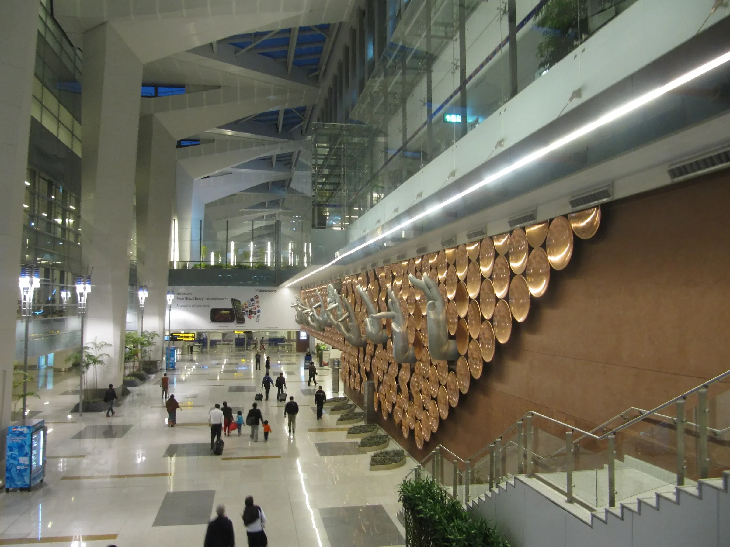 A wall of hand-gesture sculptures along a concourse in Terminal 3 at Delhi airport