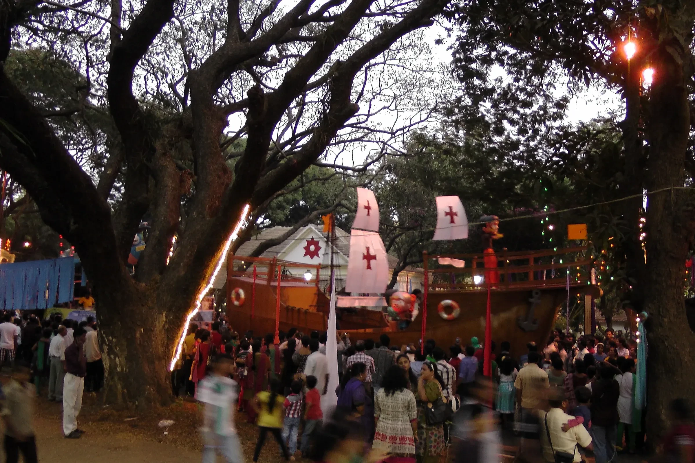 Crowds gathered at dusk beside a ship-shaped float at the Goa Carnival in Panaji