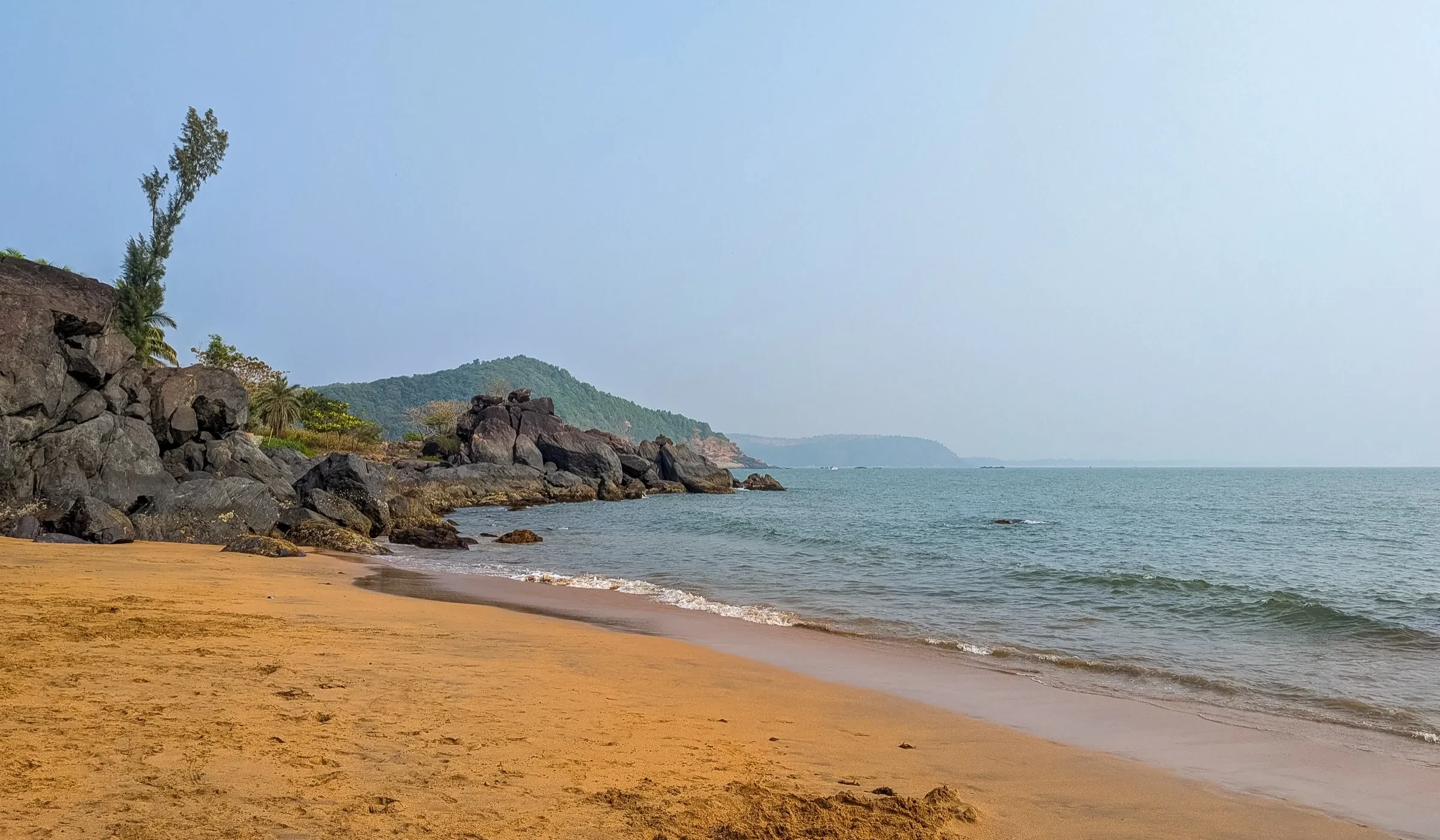 The sand and rocks of Half Moon Beach in Gokarna