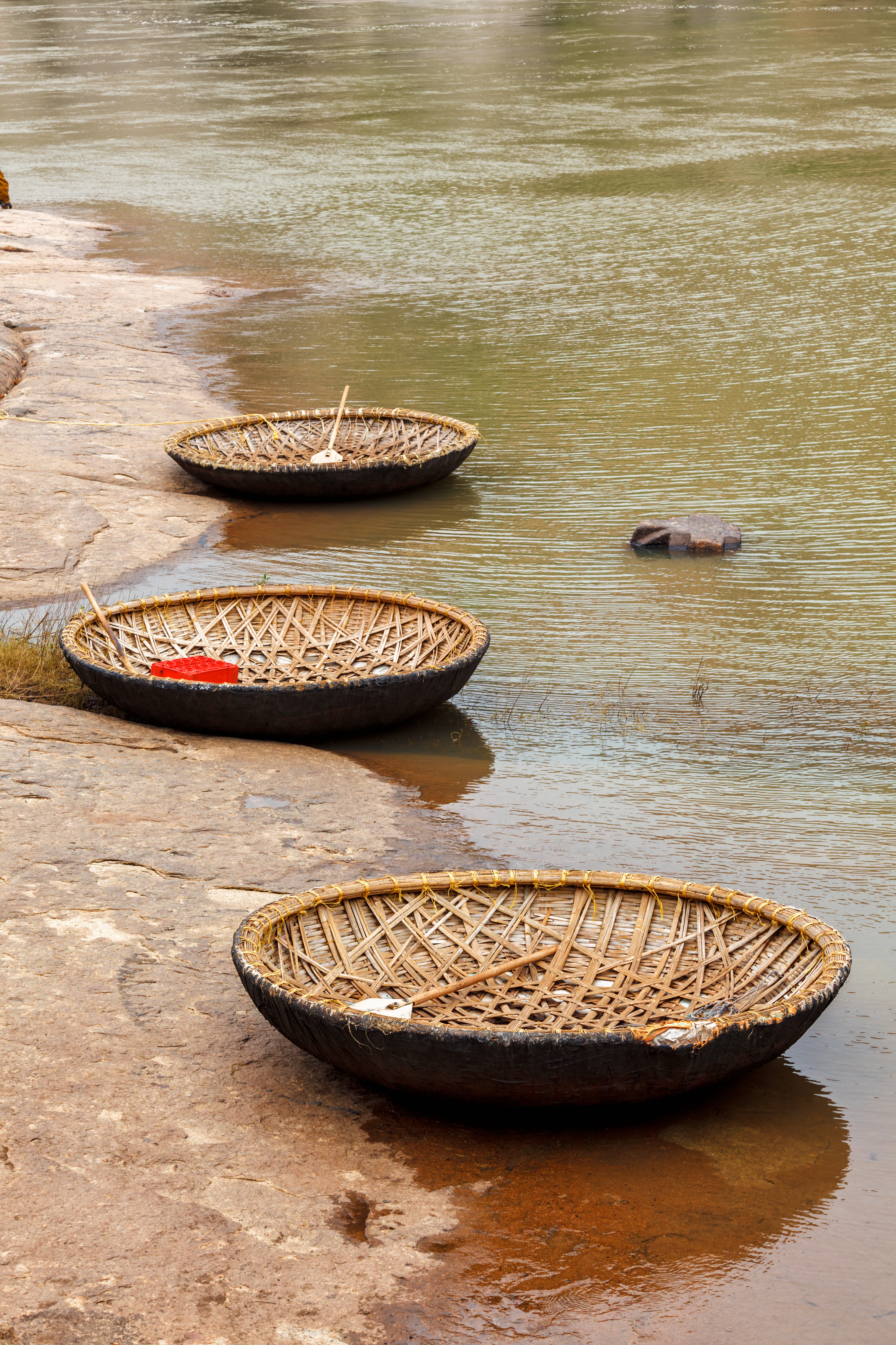 A woven coracle boat crossing the Tungabhadra River near Hampi