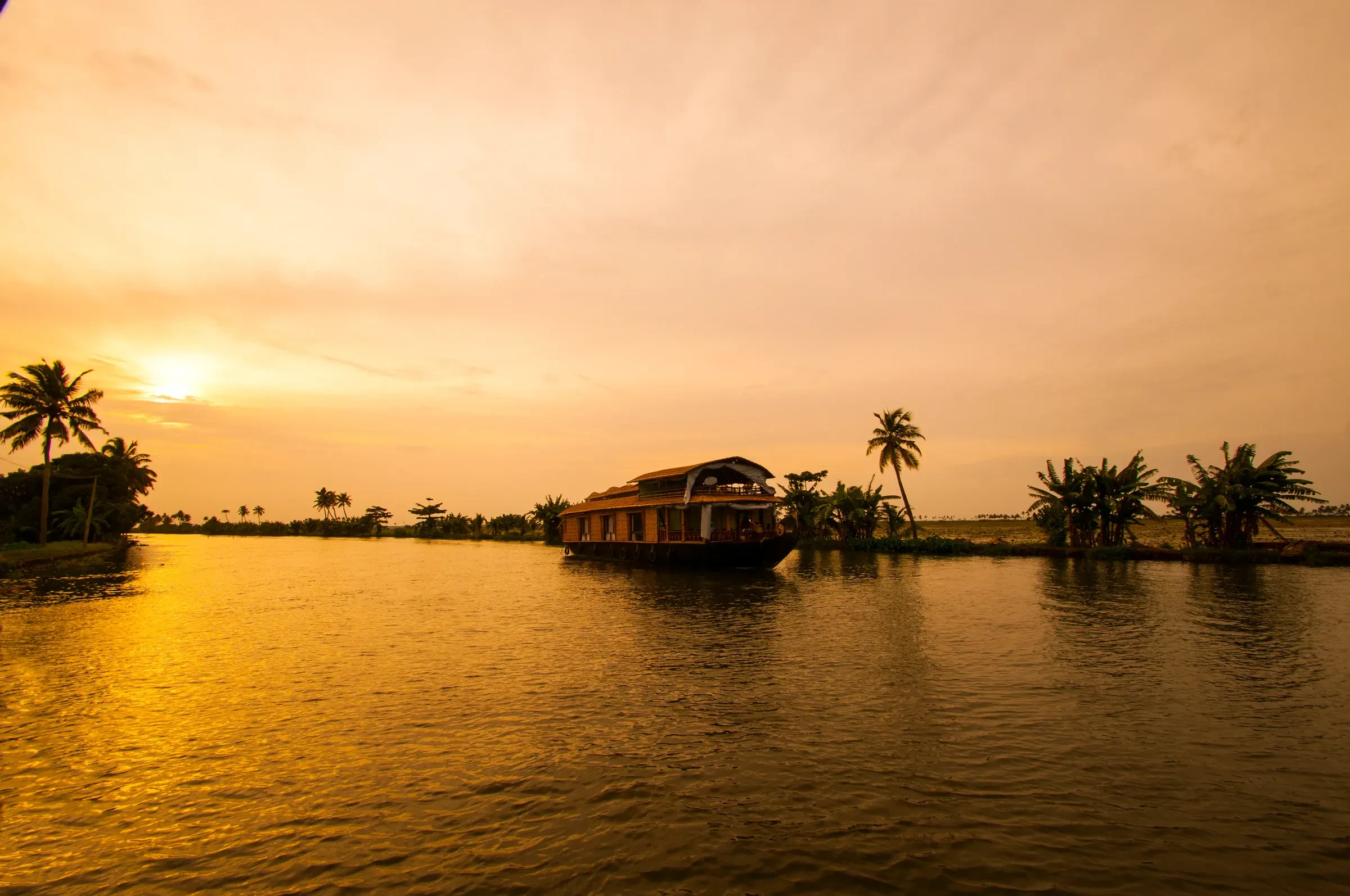 A wooden houseboat moored on the Kerala backwaters near Alleppey