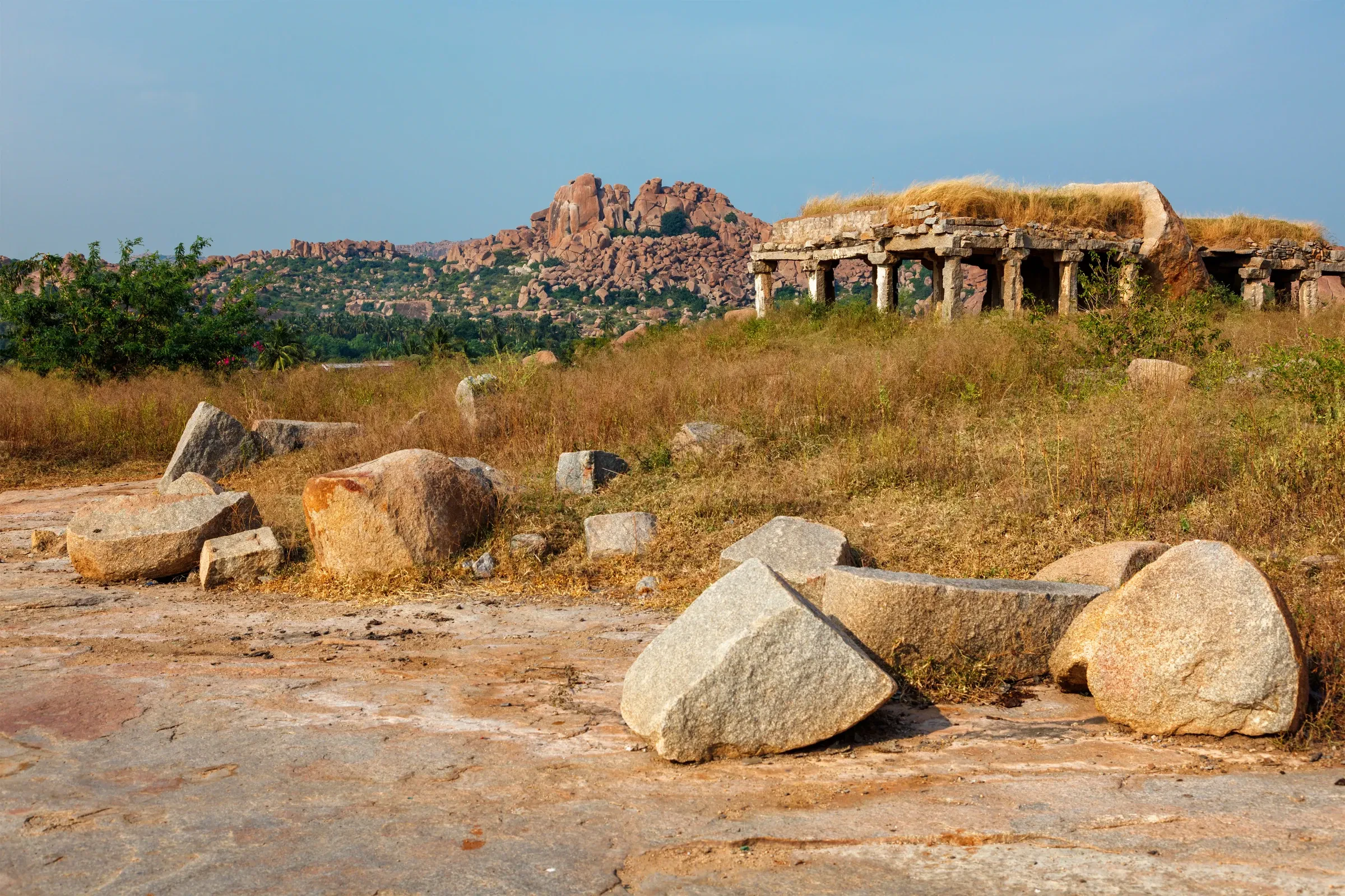 Boulders and a ruined pillared hall at Hampi, Karnataka