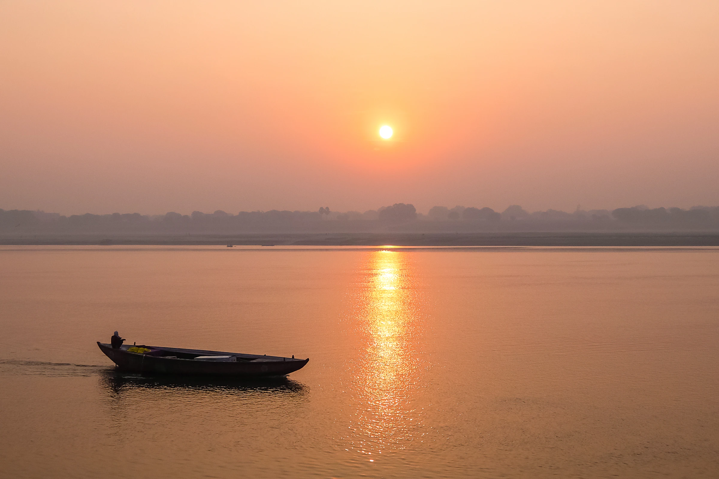 Sunrise over the ghats of Varanasi, seen from a rowing boat on the Ganges