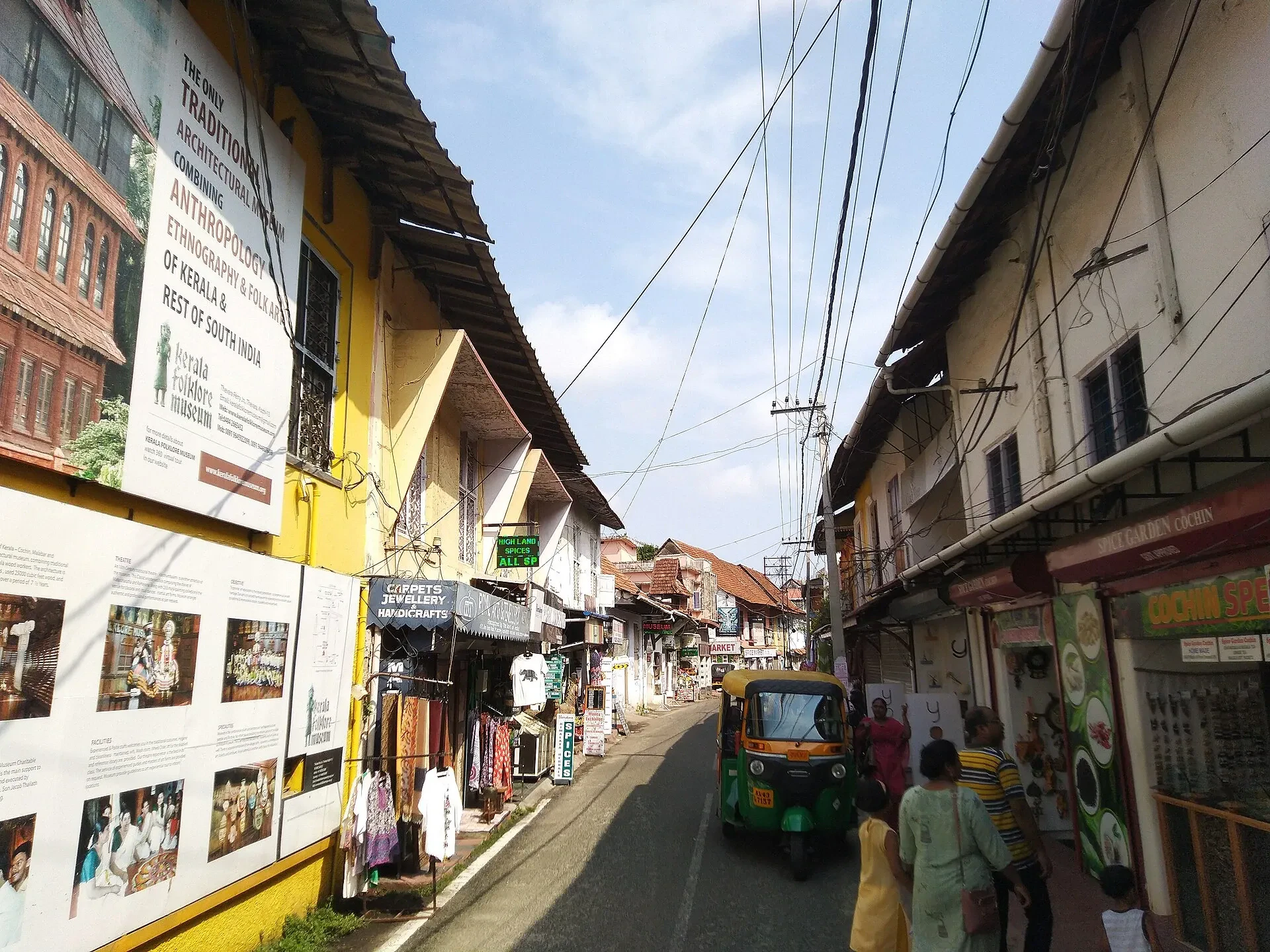 Shopfronts along Jew Street in Mattancherry, with heritage information boards on the left