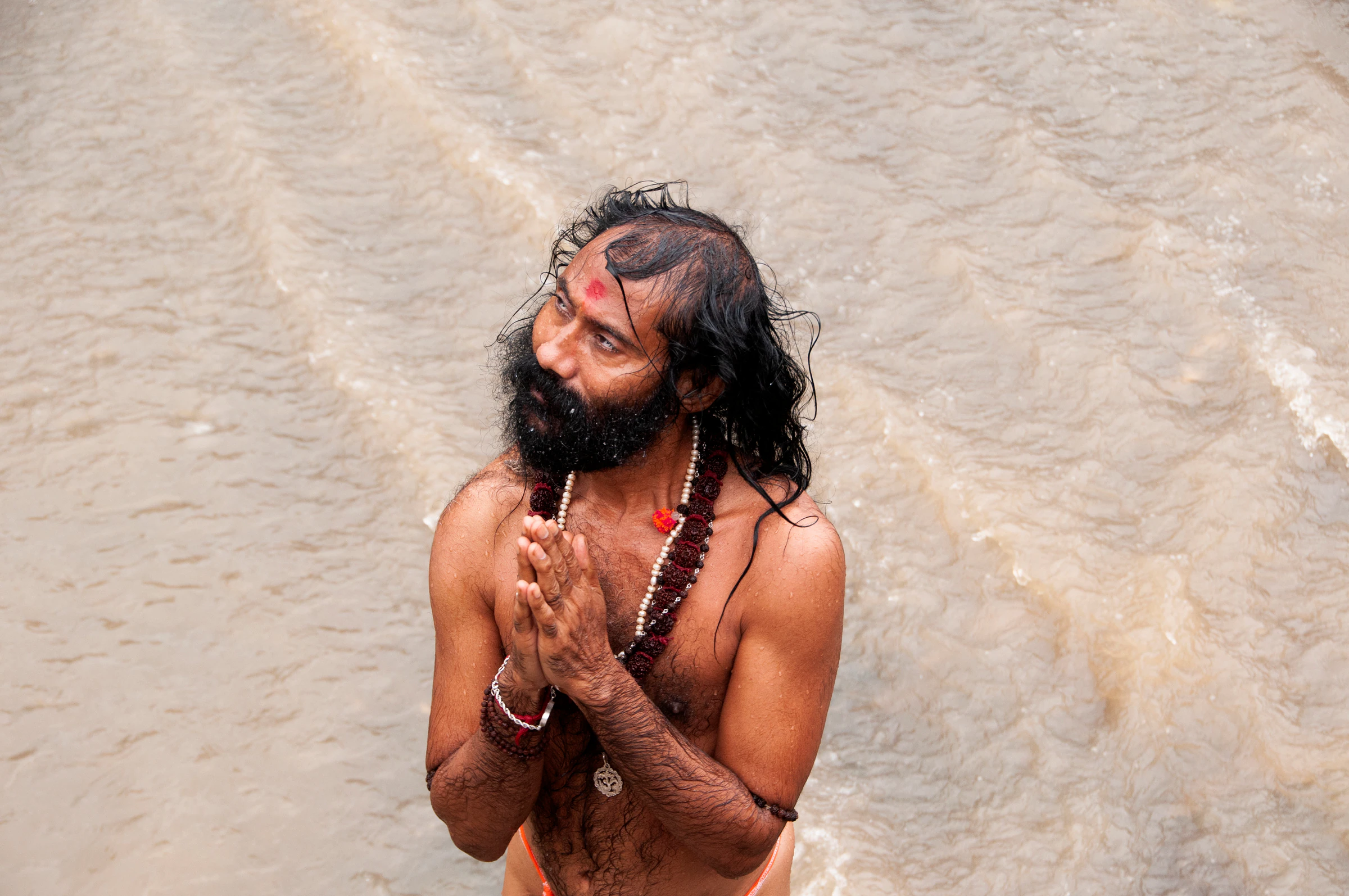 Naga sadhus, ash-covered ascetics, leading a procession at Kumbh Mela