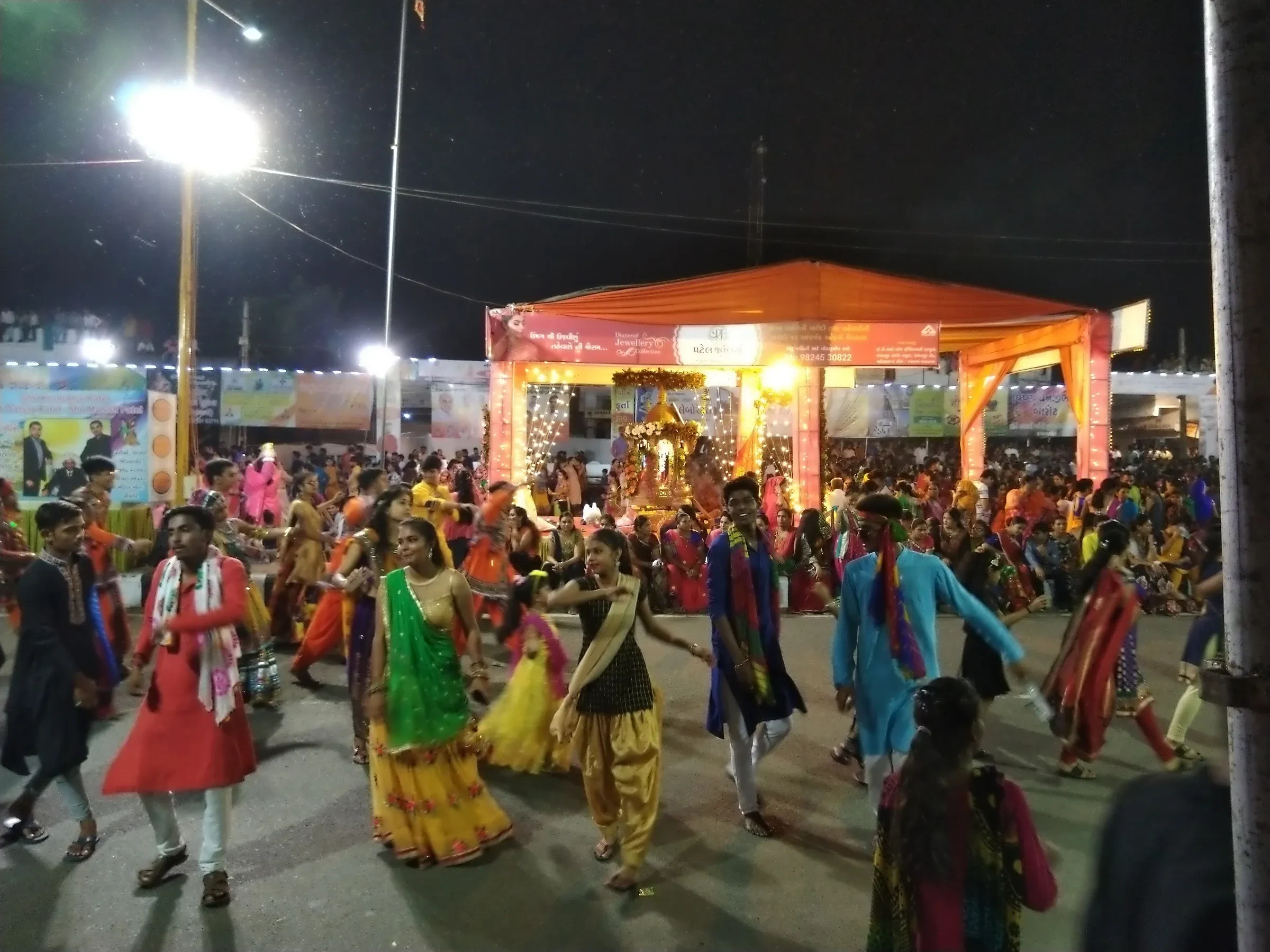 Dancers in colourful traditional dress circling at a night Garba ground in Mehsana, Gujarat