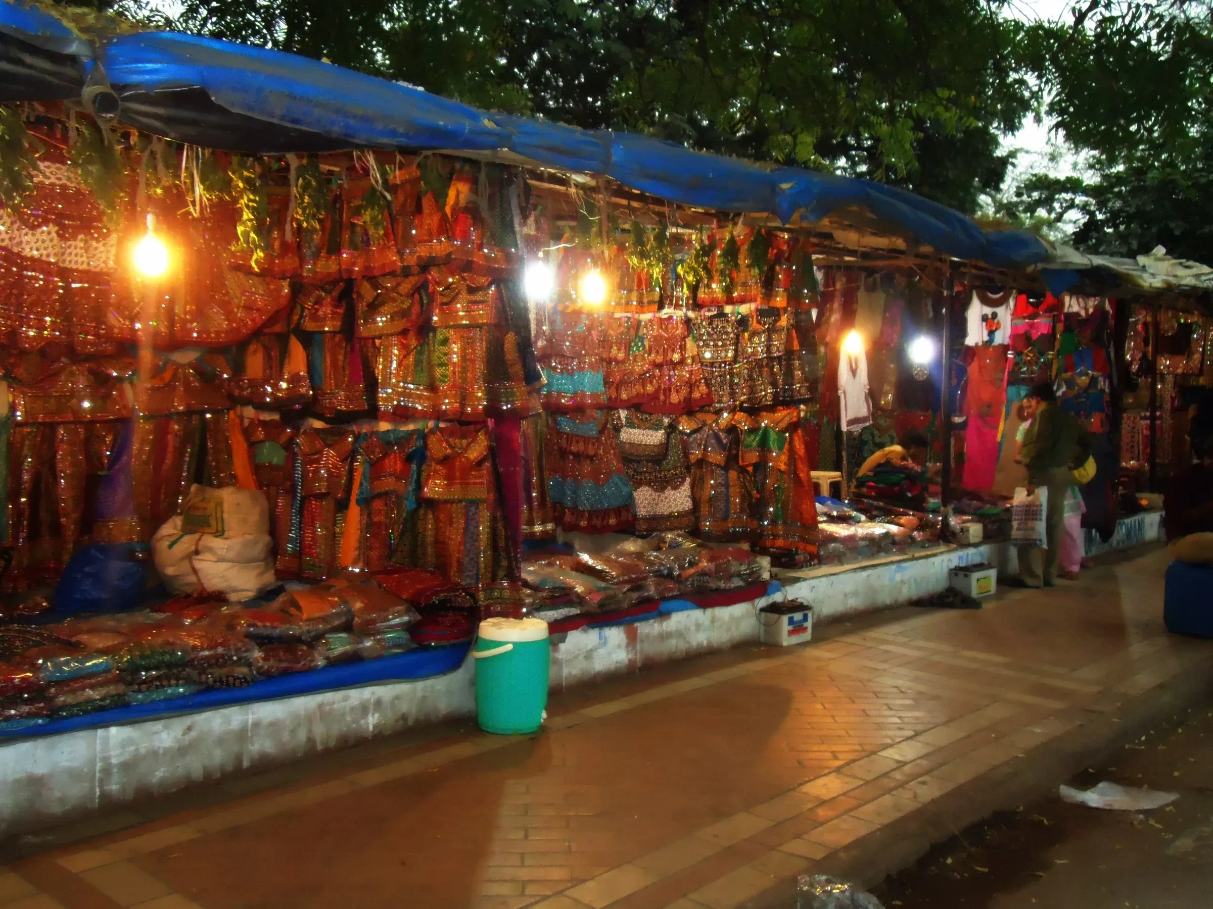 A night market stall near Law Garden in Ahmedabad hung with embroidered chaniya choli outfits