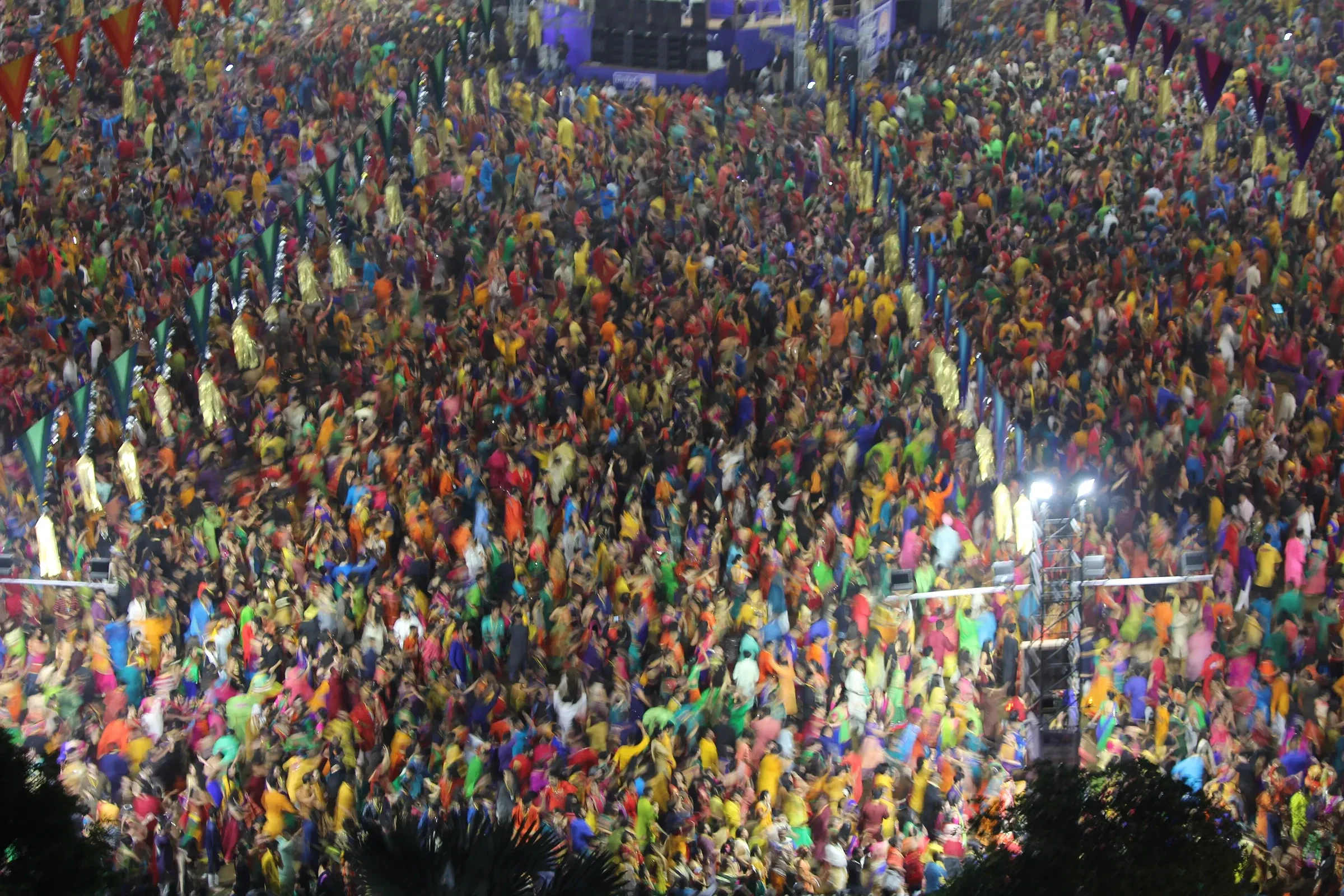 A huge crowd in colourful traditional dress dancing Garba at a Navratri celebration in Vadodara