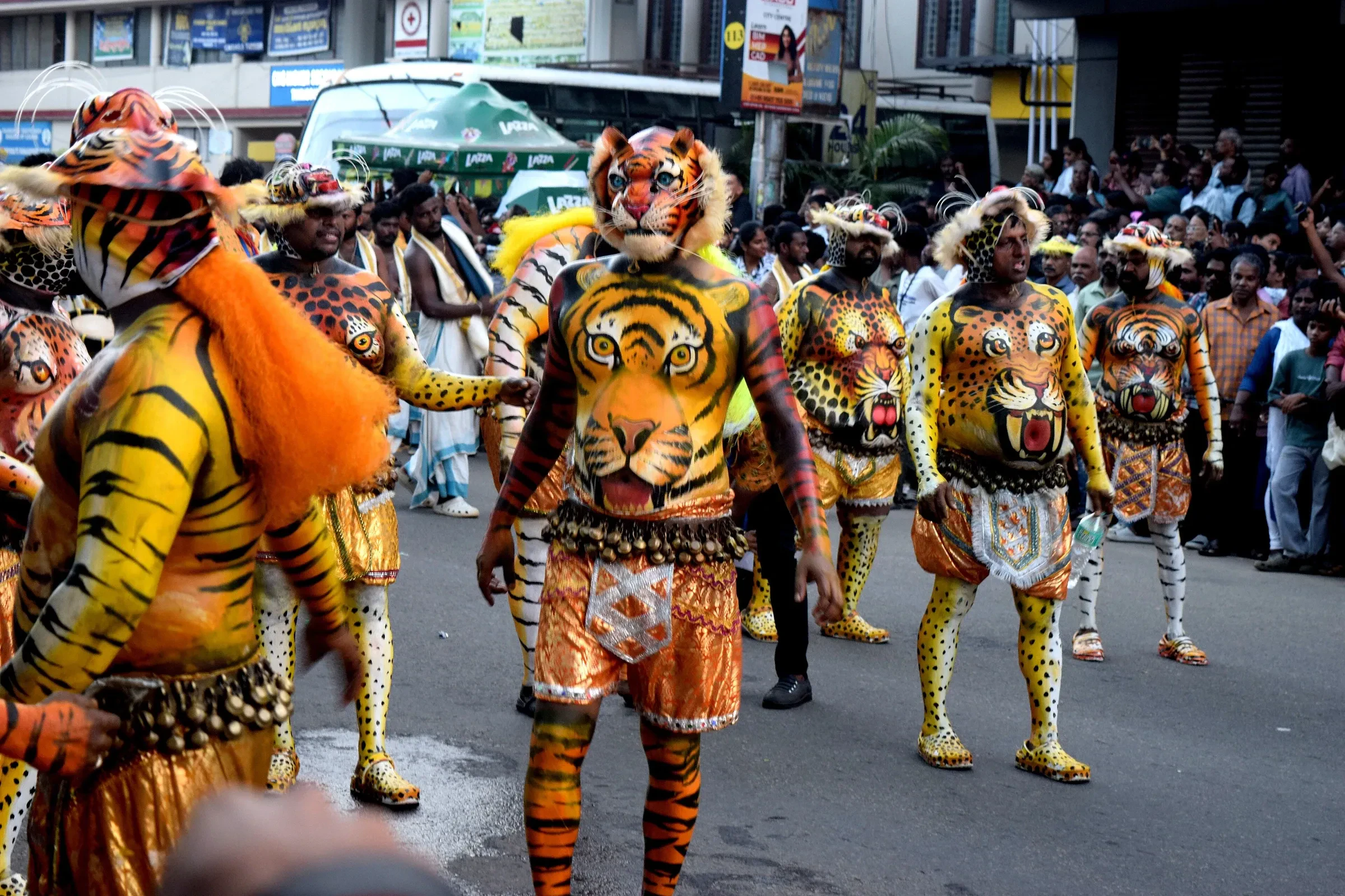 Pulikali performers painted as tigers dancing through Thrissur's streets
