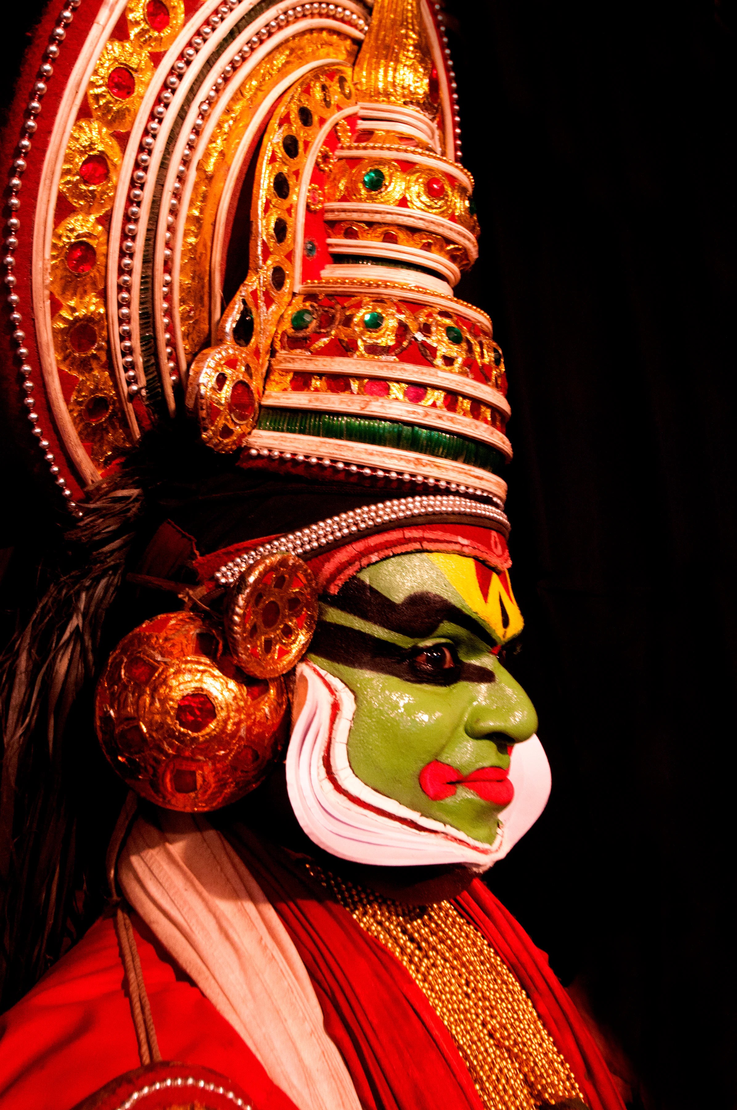 A Kathakali dancer in traditional costume and makeup, a classical Kerala art form often performed in festival season